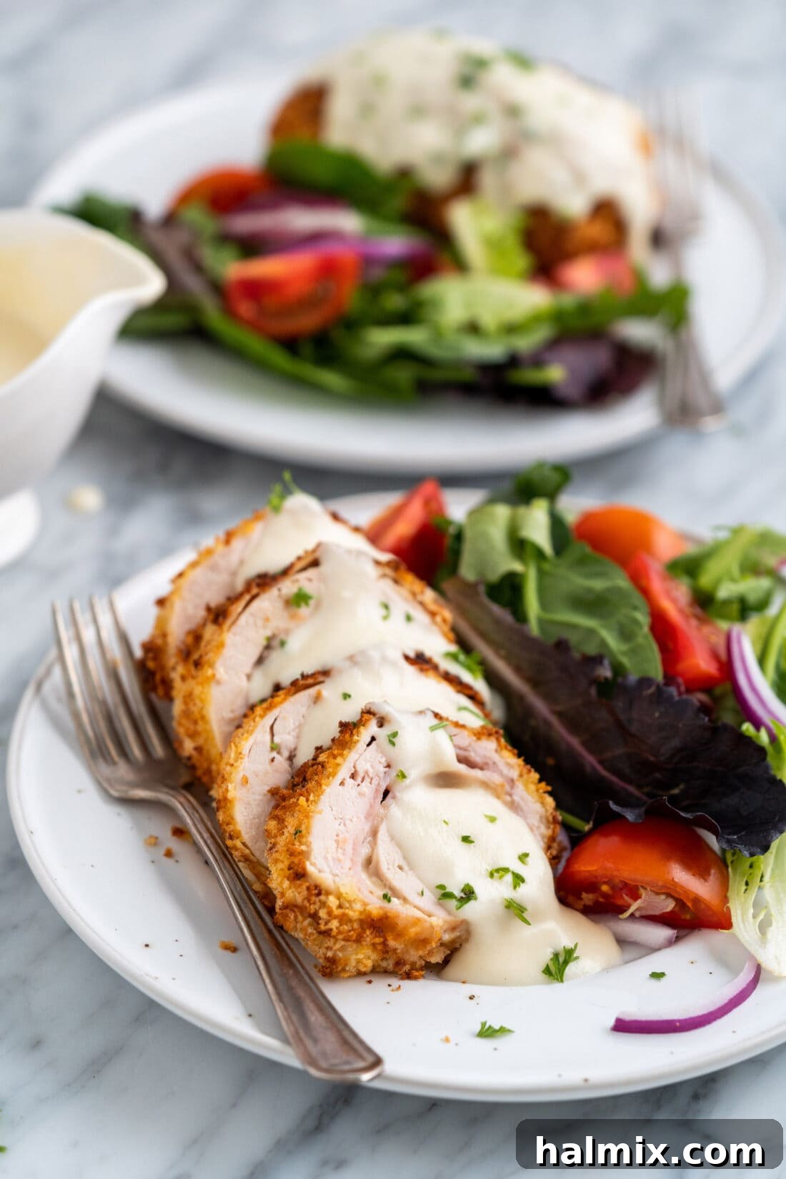 Crispy Air Fryer Chicken Cordon Bleu 17 A plated Air Fryer Chicken Cordon Bleu alongside a fresh green salad, making a complete meal.