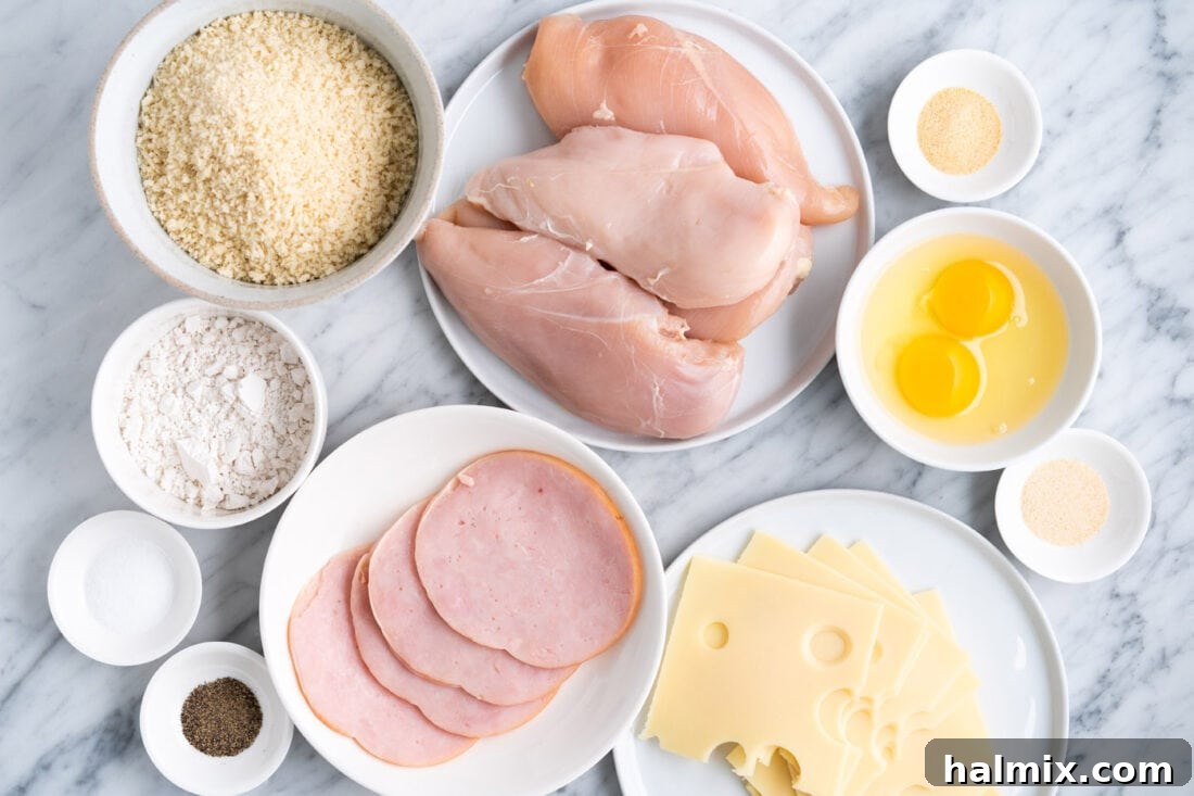 Crispy Air Fryer Chicken Cordon Bleu 4 A collection of fresh ingredients laid out for making Air Fryer Chicken Cordon Bleu, including chicken, ham, and cheese.