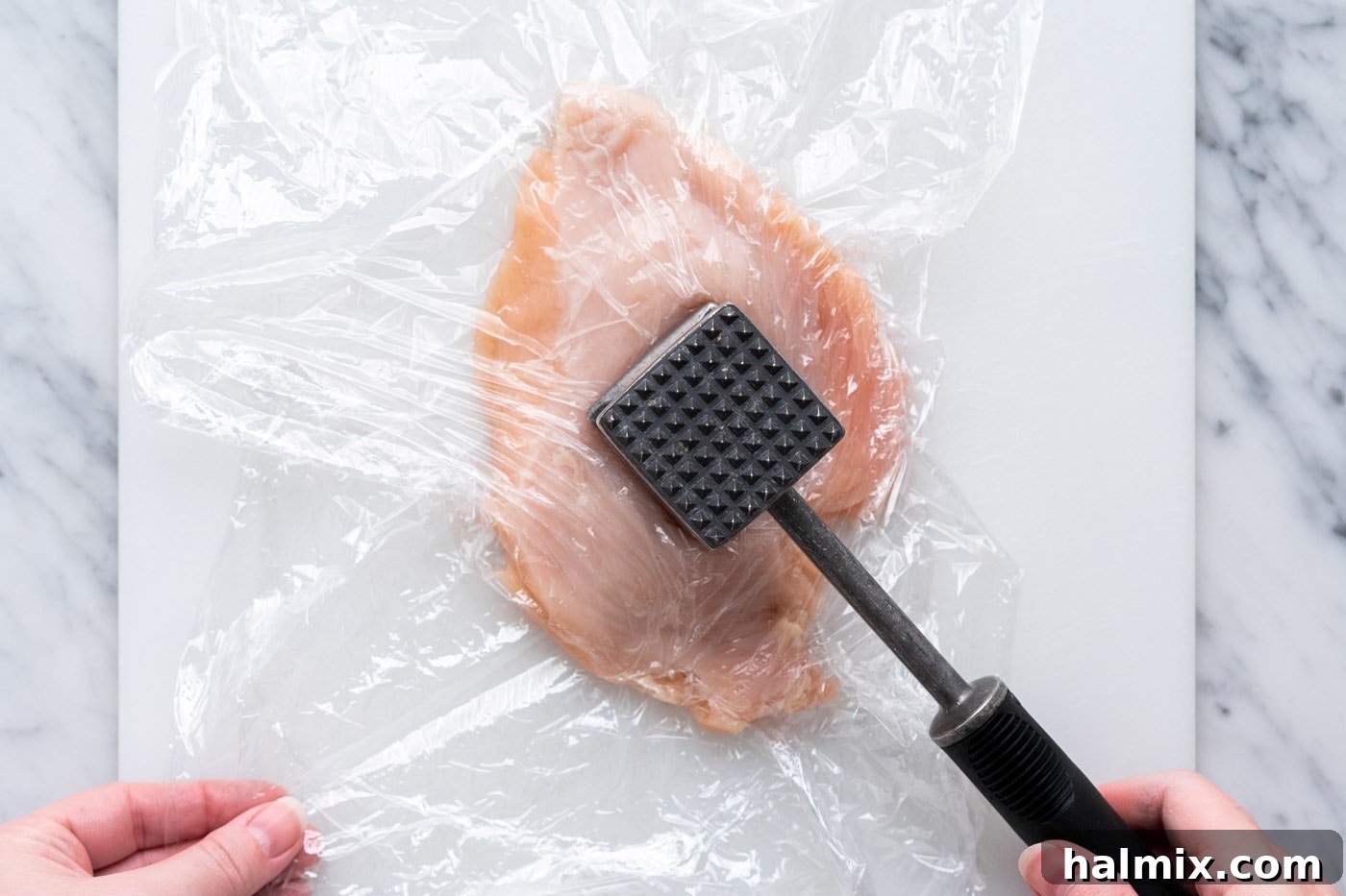 Crispy Air Fryer Chicken Cordon Bleu 6 Pounding chicken breast with a meat mallet to flatten it to an even thickness.