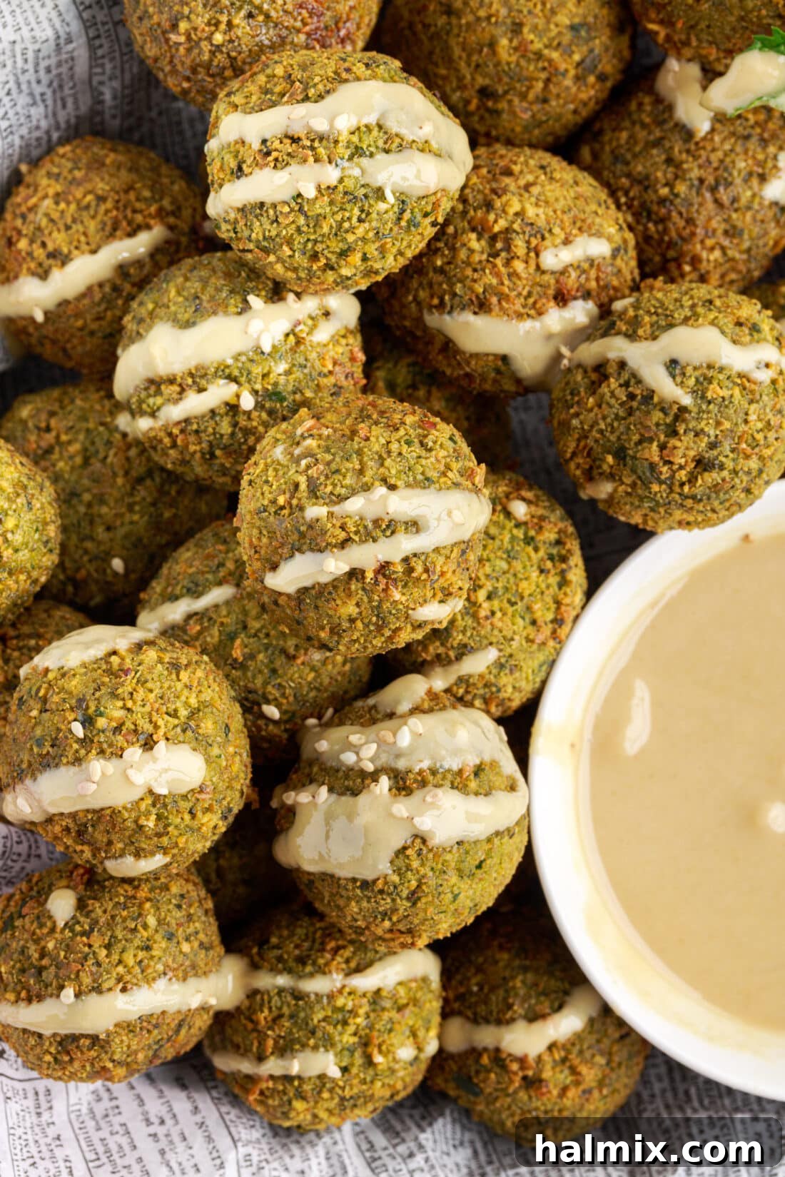 The Golden Chickpea Delight 3 Falafel with sauce drizzled on top