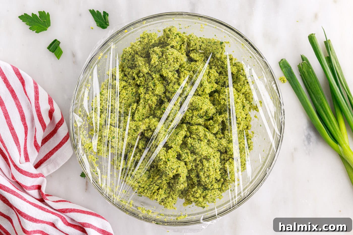 The Golden Chickpea Delight 9 falafel mixture covered with plastic wrap