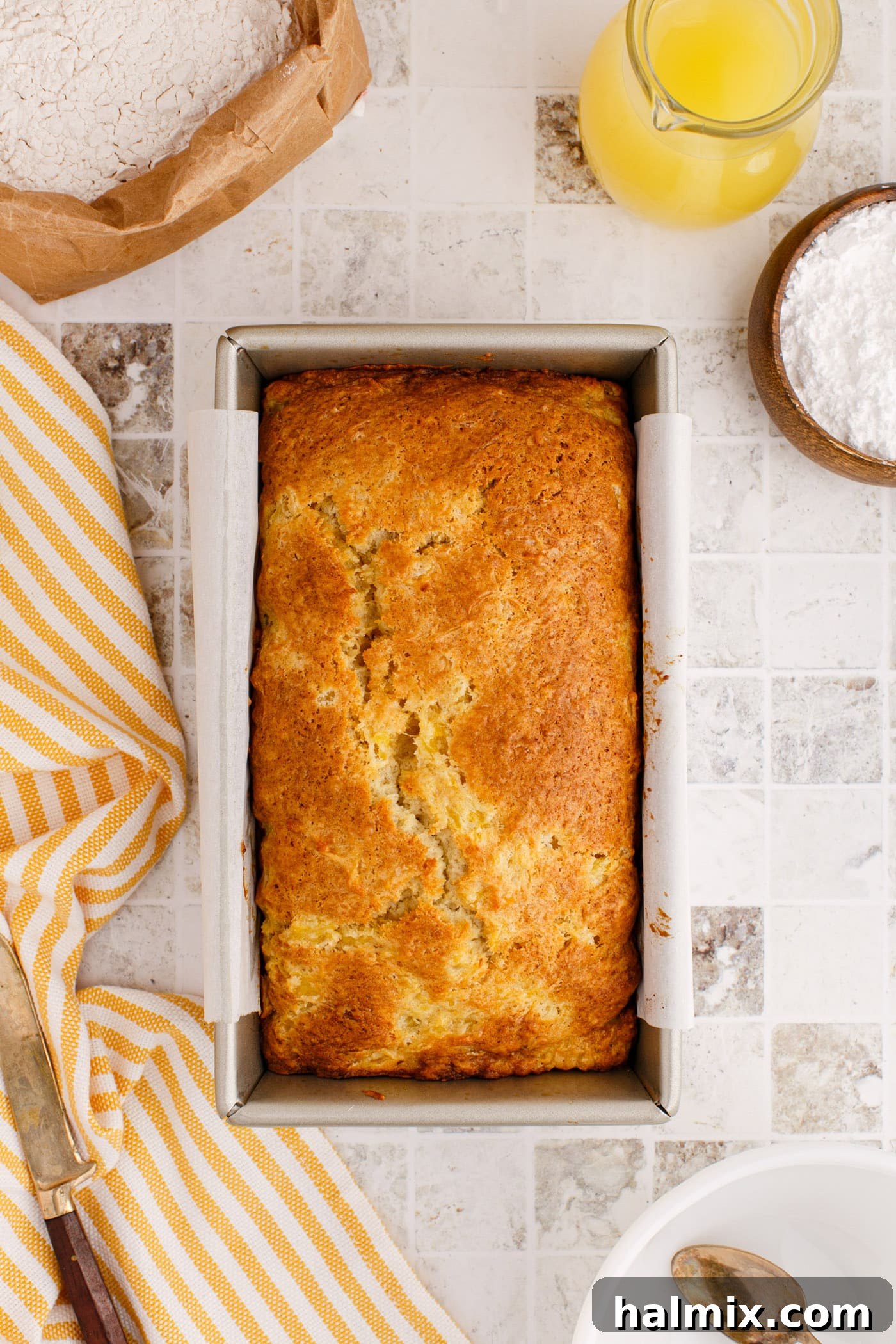 Freshly baked pineapple quick bread cooling in its loaf pan