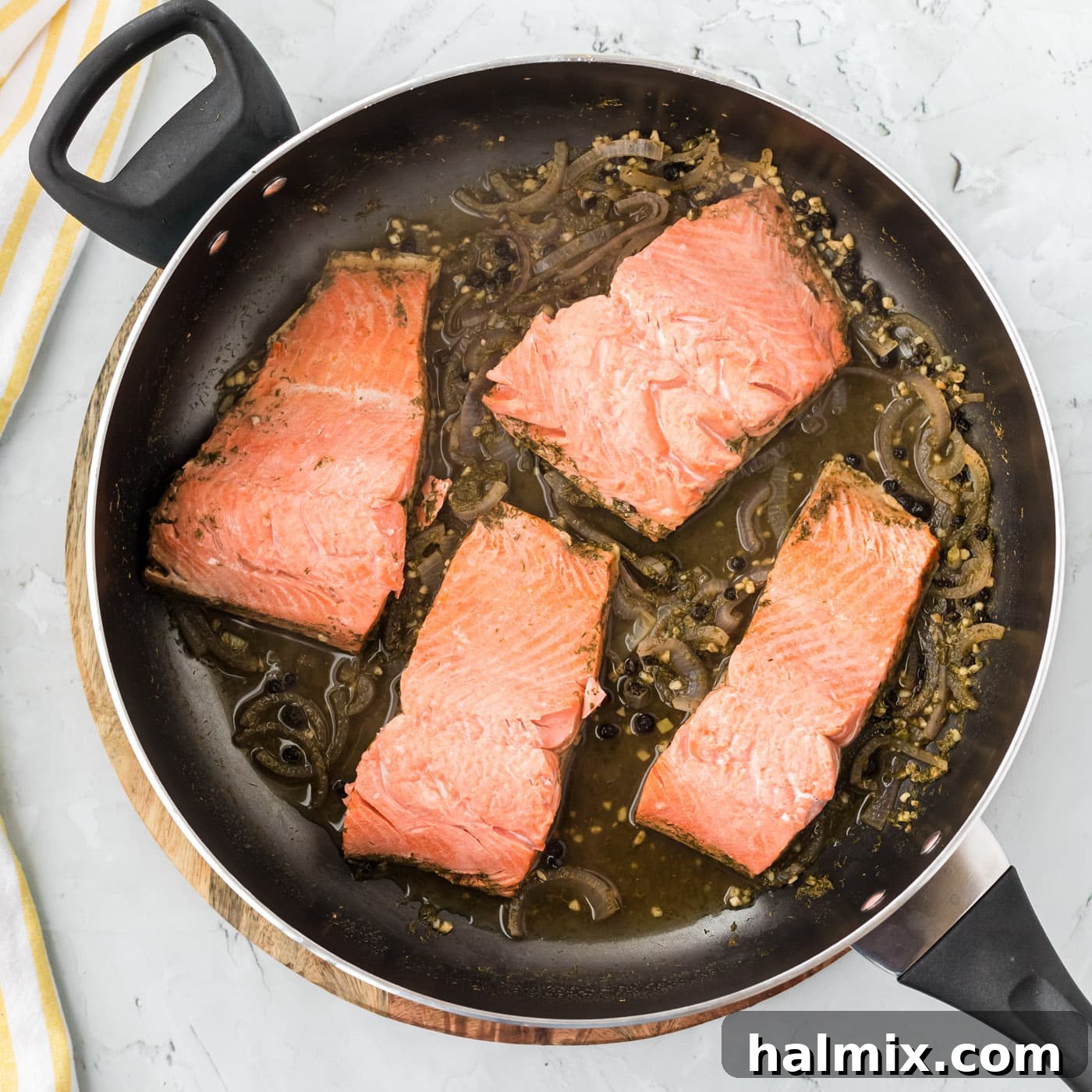 Silently, I'm identifying the core request: translate and "originalize" a Turkish title into English, ensuring only one plain English title is output, with no special characters or introductory phrases. The input is "Poached Salmon". This is already English. Therefore, the task is to "originalize" Poached Salmon into something similar but perhaps more evocative or descriptive, while still being plain English. 1. **Analyze "Poached Salmon"**: It's a straightforward description of a dish.
2. **Brainstorm variations/enhancements**: * Focus on the *method*: Gently Poached Salmon, Perfectly Poached Salmon. * Focus on the *result/experience*: Delicate Poached Salmon, Succulent Poached Salmon. * Focus on *simplicity/elegance*: Simple Poached Salmon, Elegant Poached Salmon. * Add a *pairing/context* (if it were a recipe, but here it's just a title): Poached Salmon with Dill, Lemon Poached Salmon. (Too specific if the original wasn't.)
3. **Select the best "originalization"**: I need one that sounds a little more appealing or descriptive than just "Poached Salmon" without drastically changing its meaning or adding ingredients that aren't implied. "Delicate Poached Salmon" or "Succulent Poached Salmon" both work well to enhance the basic description. "Perfectly Poached Salmon" is also good. Let's go with "Delicate Poached Salmon" as it evokes both the texture and the careful cooking method. 5 Salmon fillets gently poaching in a skillet with aromatic liquid, covered to steam and cook through.