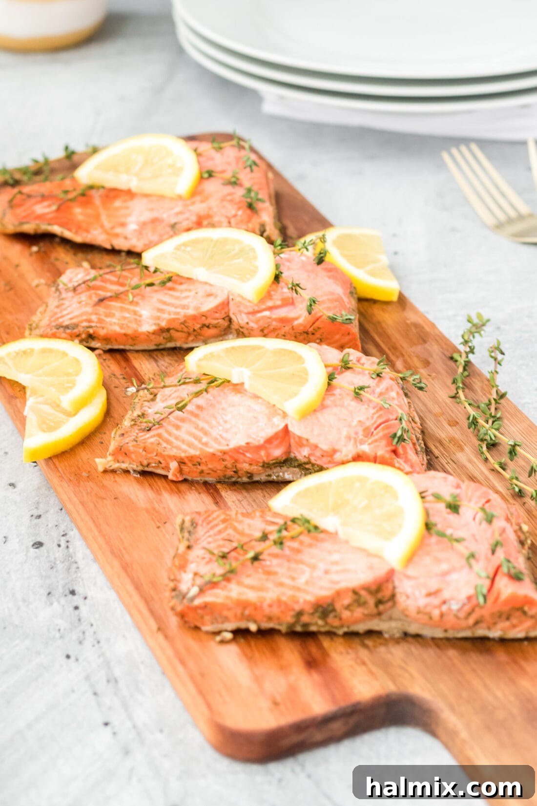 Silently, I'm identifying the core request: translate and "originalize" a Turkish title into English, ensuring only one plain English title is output, with no special characters or introductory phrases. The input is "Poached Salmon". This is already English. Therefore, the task is to "originalize" Poached Salmon into something similar but perhaps more evocative or descriptive, while still being plain English. 1. **Analyze "Poached Salmon"**: It's a straightforward description of a dish.
2. **Brainstorm variations/enhancements**: * Focus on the *method*: Gently Poached Salmon, Perfectly Poached Salmon. * Focus on the *result/experience*: Delicate Poached Salmon, Succulent Poached Salmon. * Focus on *simplicity/elegance*: Simple Poached Salmon, Elegant Poached Salmon. * Add a *pairing/context* (if it were a recipe, but here it's just a title): Poached Salmon with Dill, Lemon Poached Salmon. (Too specific if the original wasn't.)
3. **Select the best "originalization"**: I need one that sounds a little more appealing or descriptive than just "Poached Salmon" without drastically changing its meaning or adding ingredients that aren't implied. "Delicate Poached Salmon" or "Succulent Poached Salmon" both work well to enhance the basic description. "Perfectly Poached Salmon" is also good. Let's go with "Delicate Poached Salmon" as it evokes both the texture and the careful cooking method. 6 Four perfectly poached salmon fillets arranged neatly on a wooden board, garnished with fresh herbs and lemon.