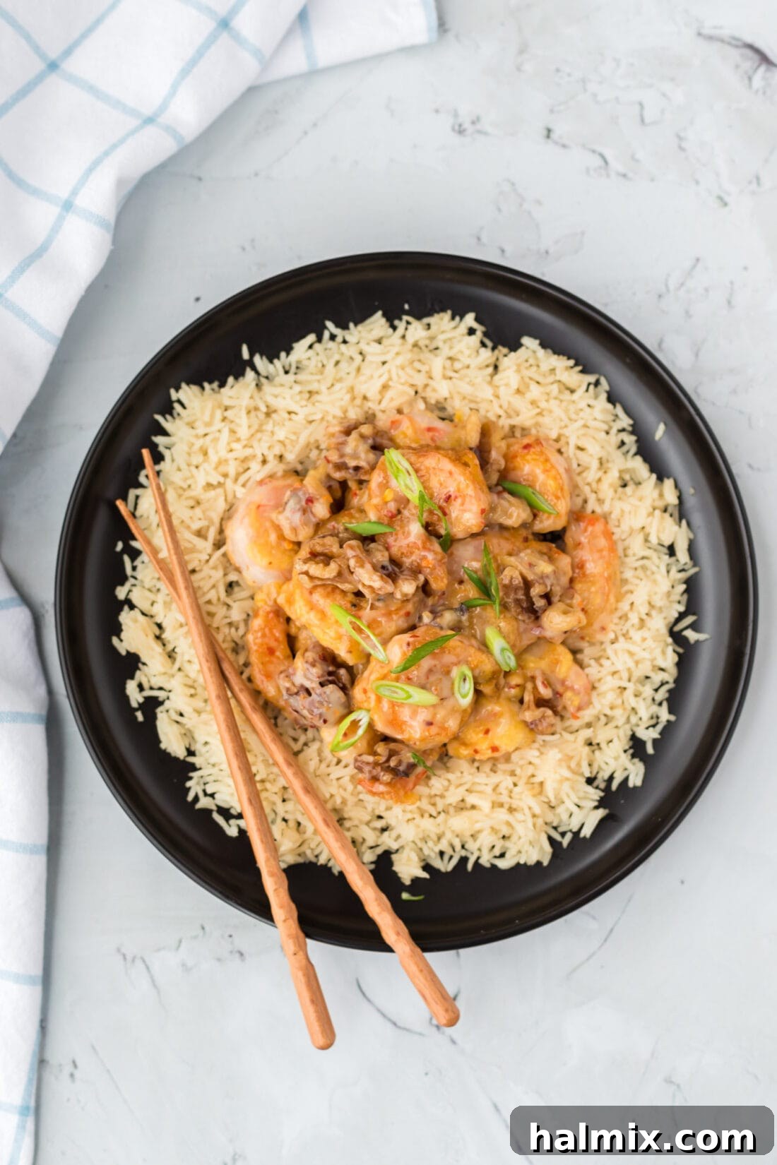 Golden Glazed Honey Walnut Shrimp 5 A generous serving of Honey Walnut Shrimp with rice and chopsticks, ready to be enjoyed