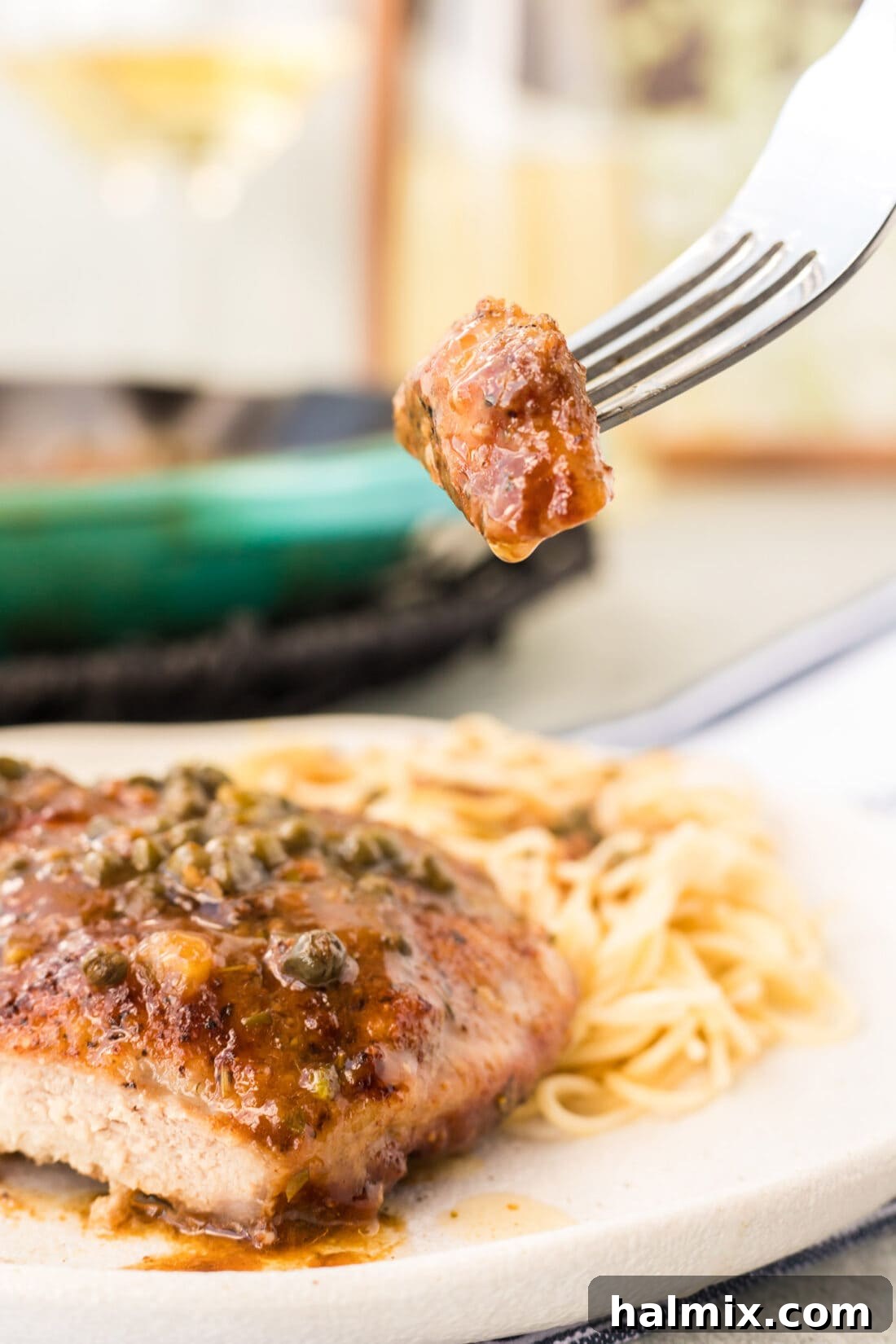 Tender Veal Cutlets with Lemon Caper Sauce 12 fork with a bite of Veal Piccata