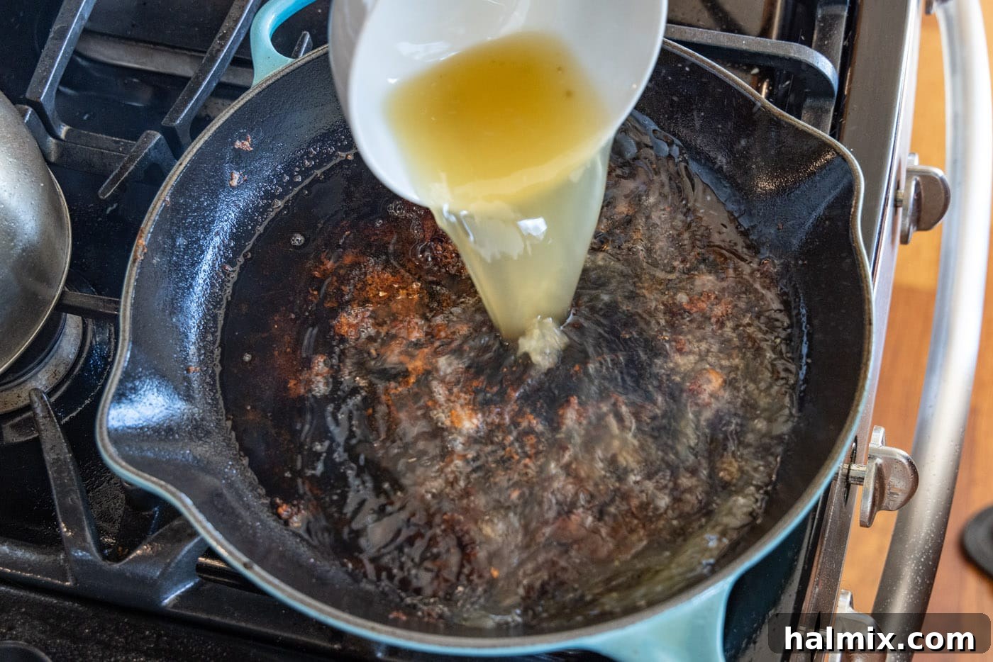 Tender Veal Cutlets with Lemon Caper Sauce 8 adding chicken broth to skillet
