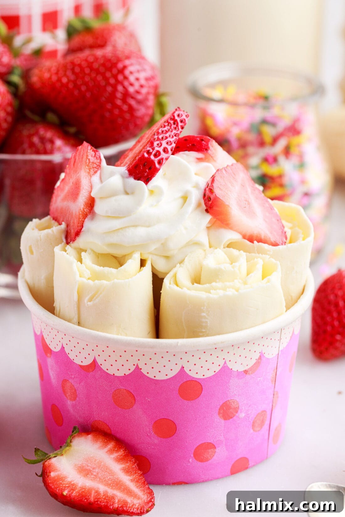 Rolled Vanilla Ice Cream in a pink container, elegantly served and ready to be enjoyed with various toppings.
