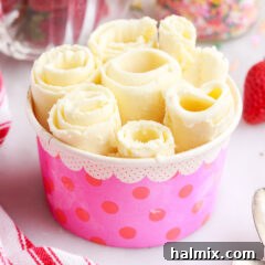 Finished rolled ice cream serving with a variety of toppings, ready for enjoyment.