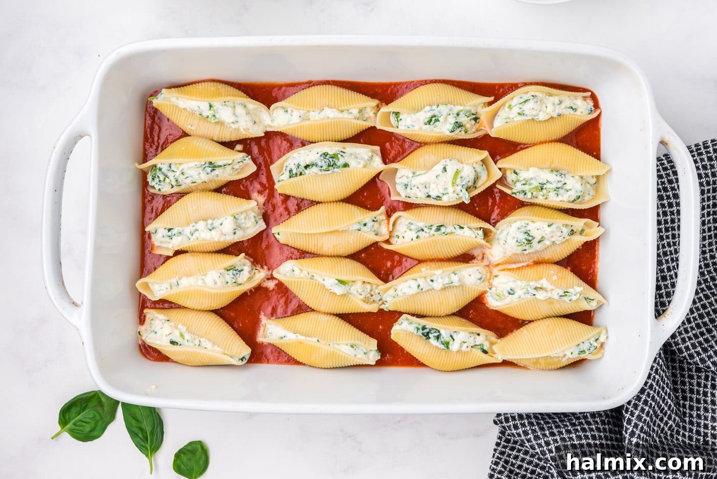 stuffed shells in a baking dish with marinara