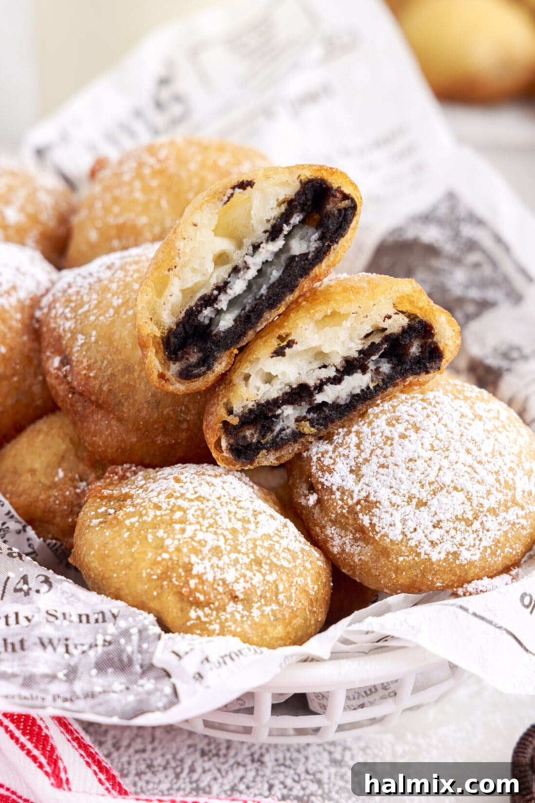 Sweet Crispy Fried Oreos 2 A basket overflowing with perfectly golden-brown homemade Fried Oreos, lightly dusted with powdered sugar, ready to be enjoyed.