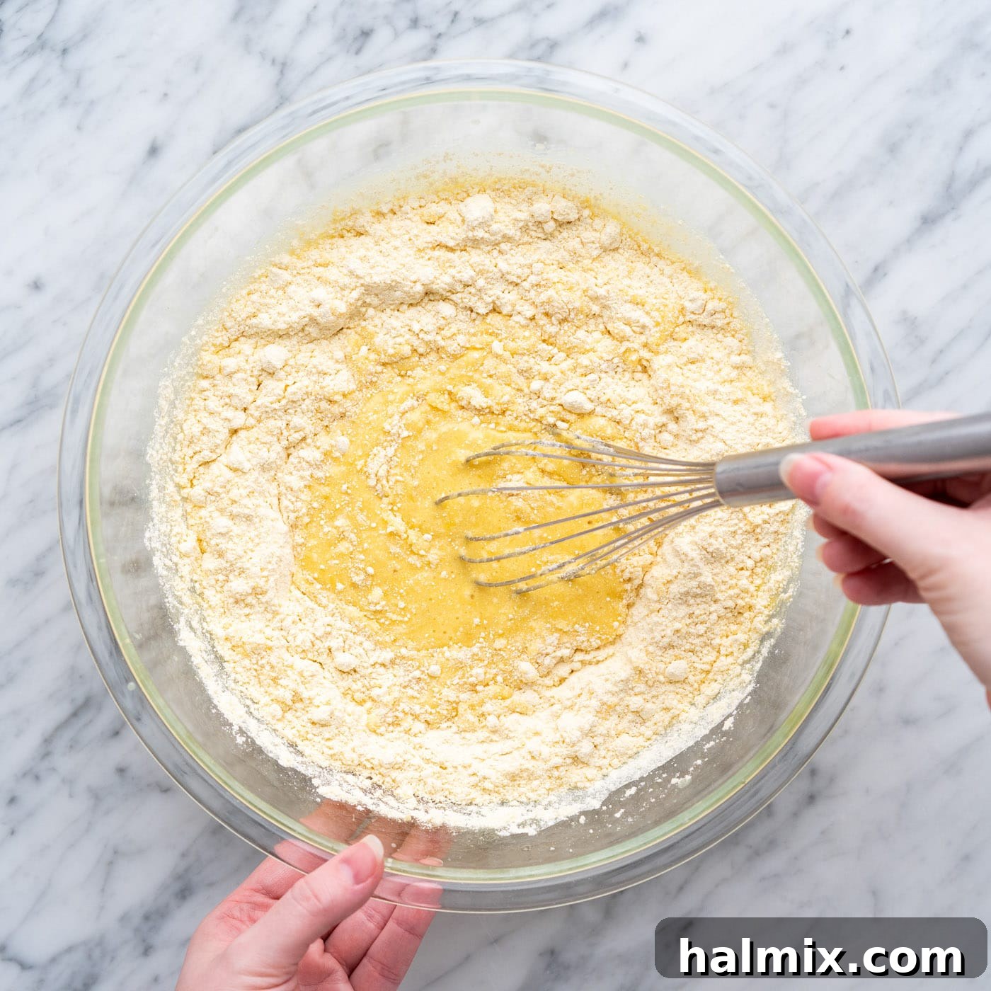 Sun-Kissed Pineapple Dream 6 whisking cake mix with crushed pineapple in a bowl, showing the developing batter