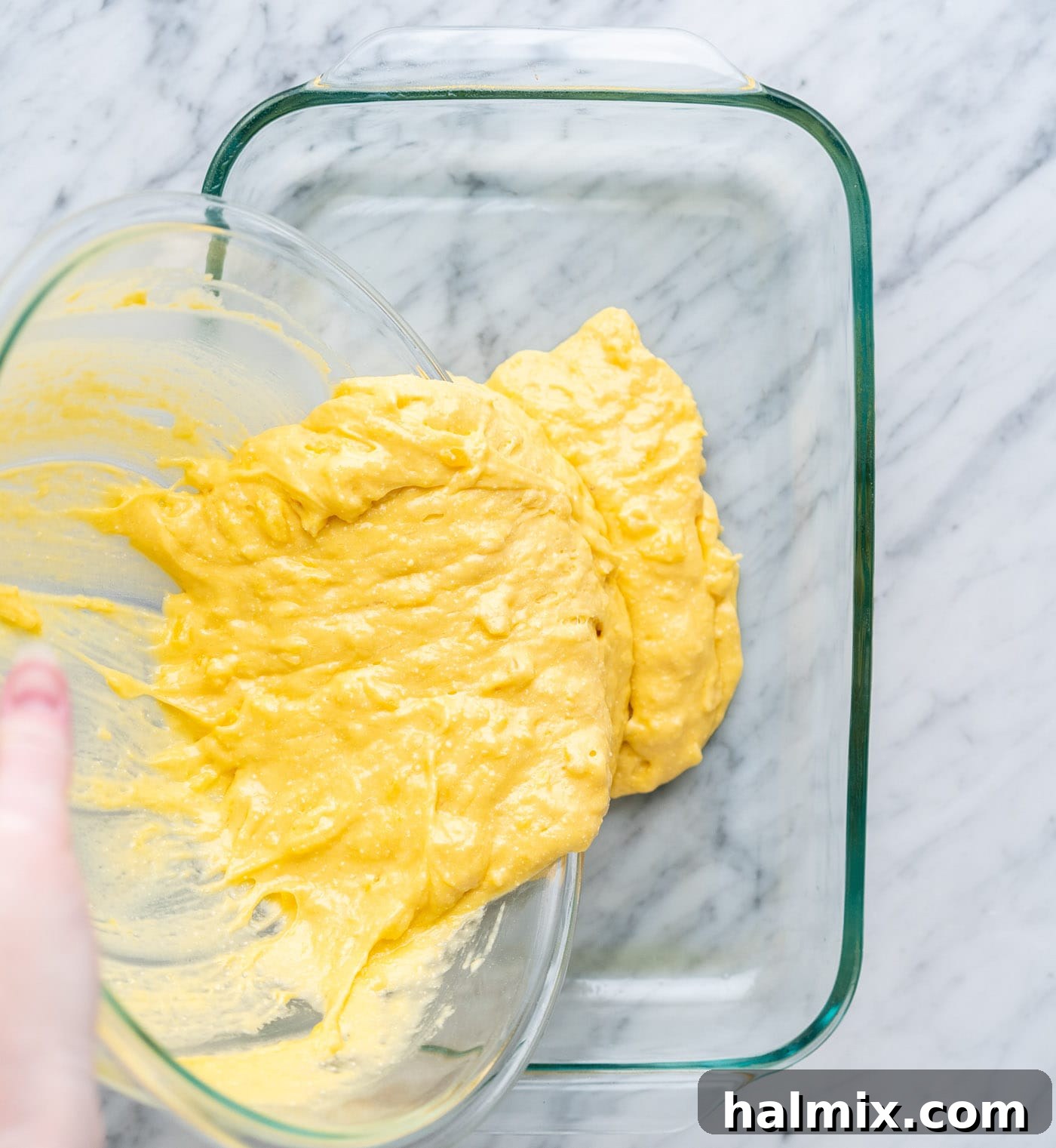 Sun-Kissed Pineapple Dream 7 pouring pineapple cake batter into a baking dish, a smooth, yellow mixture
