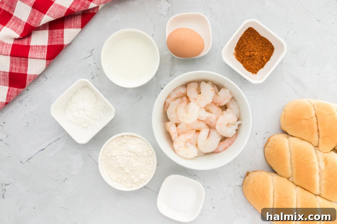 A selection of ingredients for Shrimp Po Boy including shrimp, flour, cornmeal, spices, and fresh vegetables.