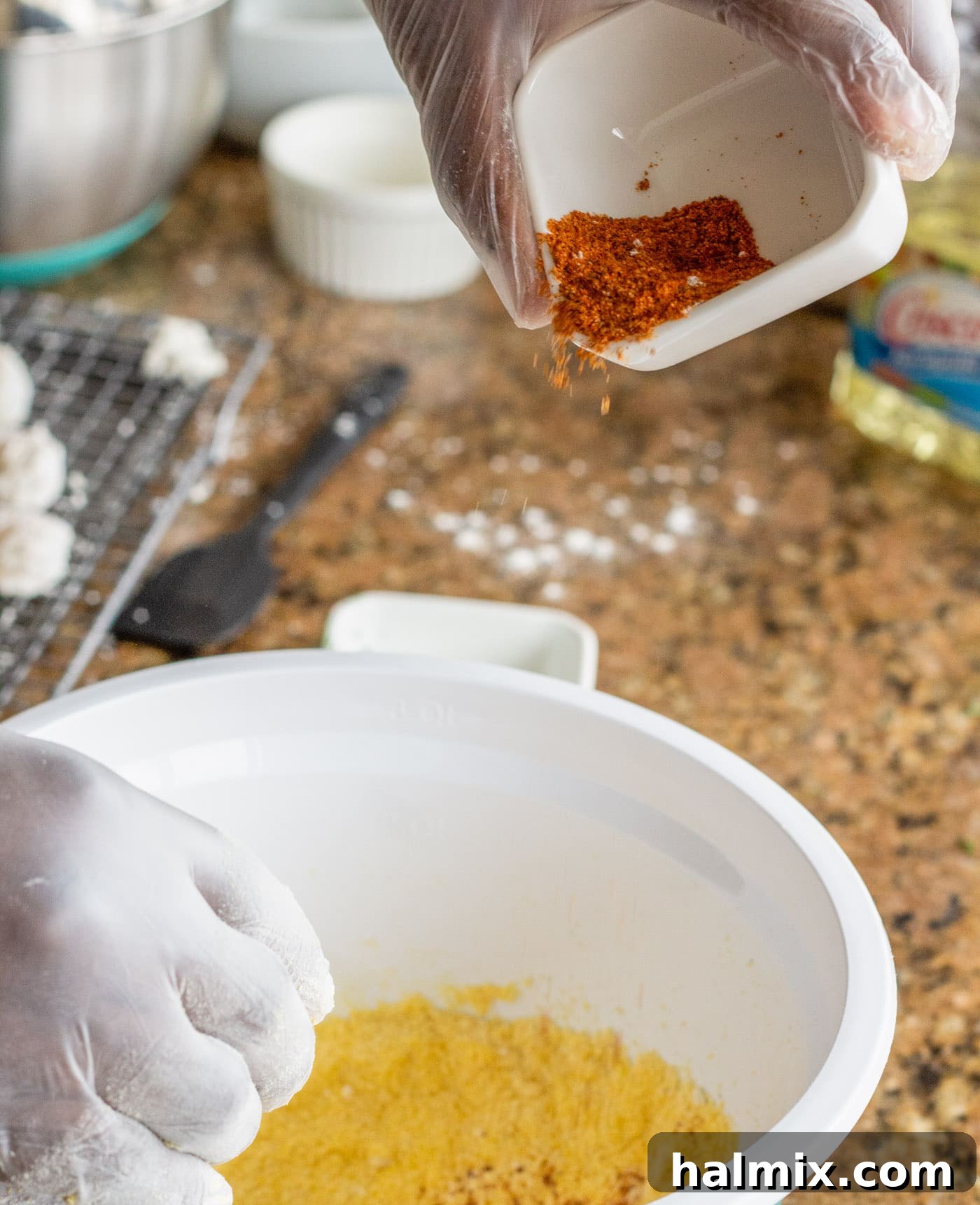 Adding seasoning to the egg and milk mixture for the shrimp breading.