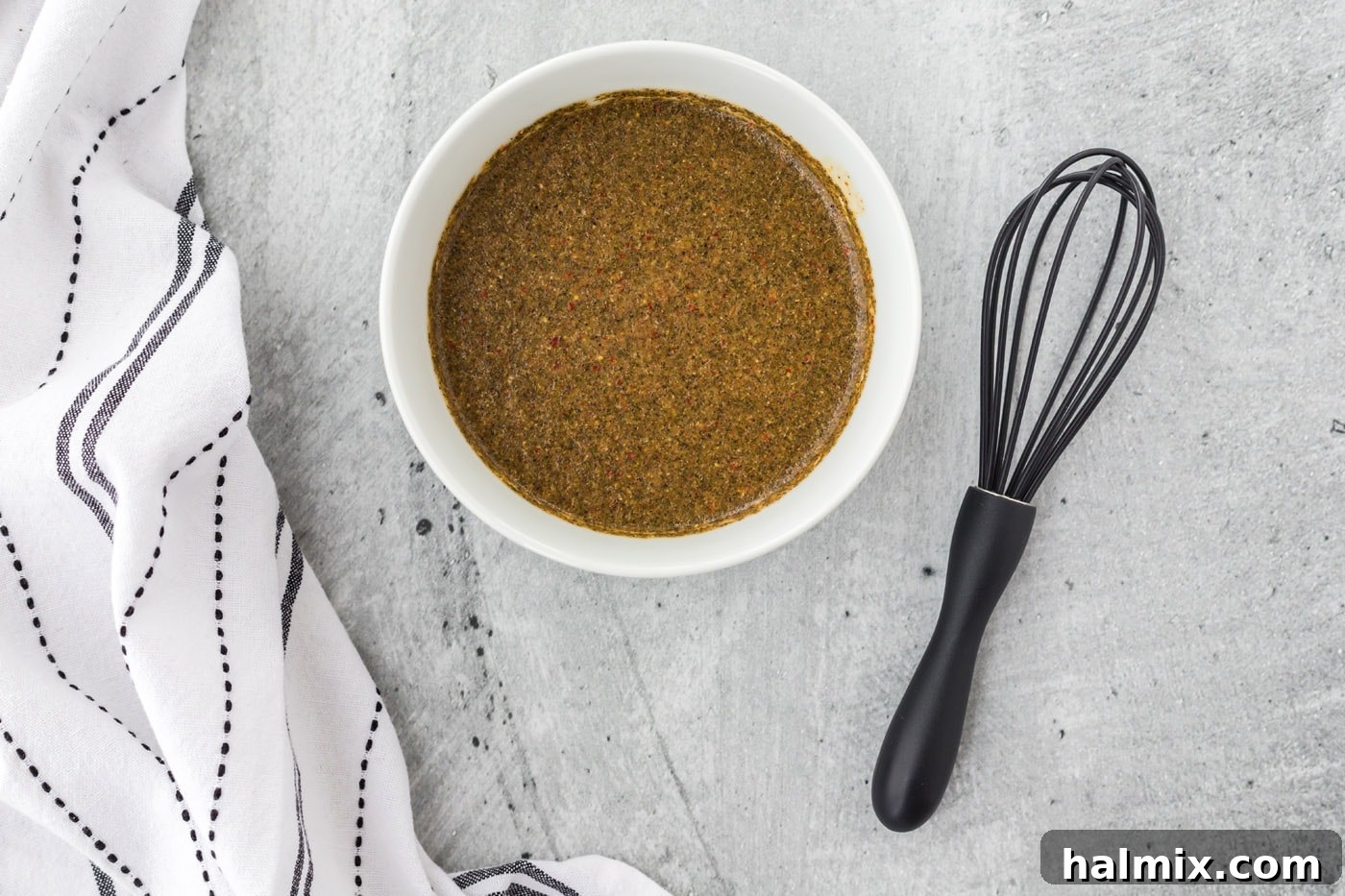 The Ultimate Steak Upgrade 5 Closeup of steak marinade mixture being blended in a bowl, showcasing its smooth texture.