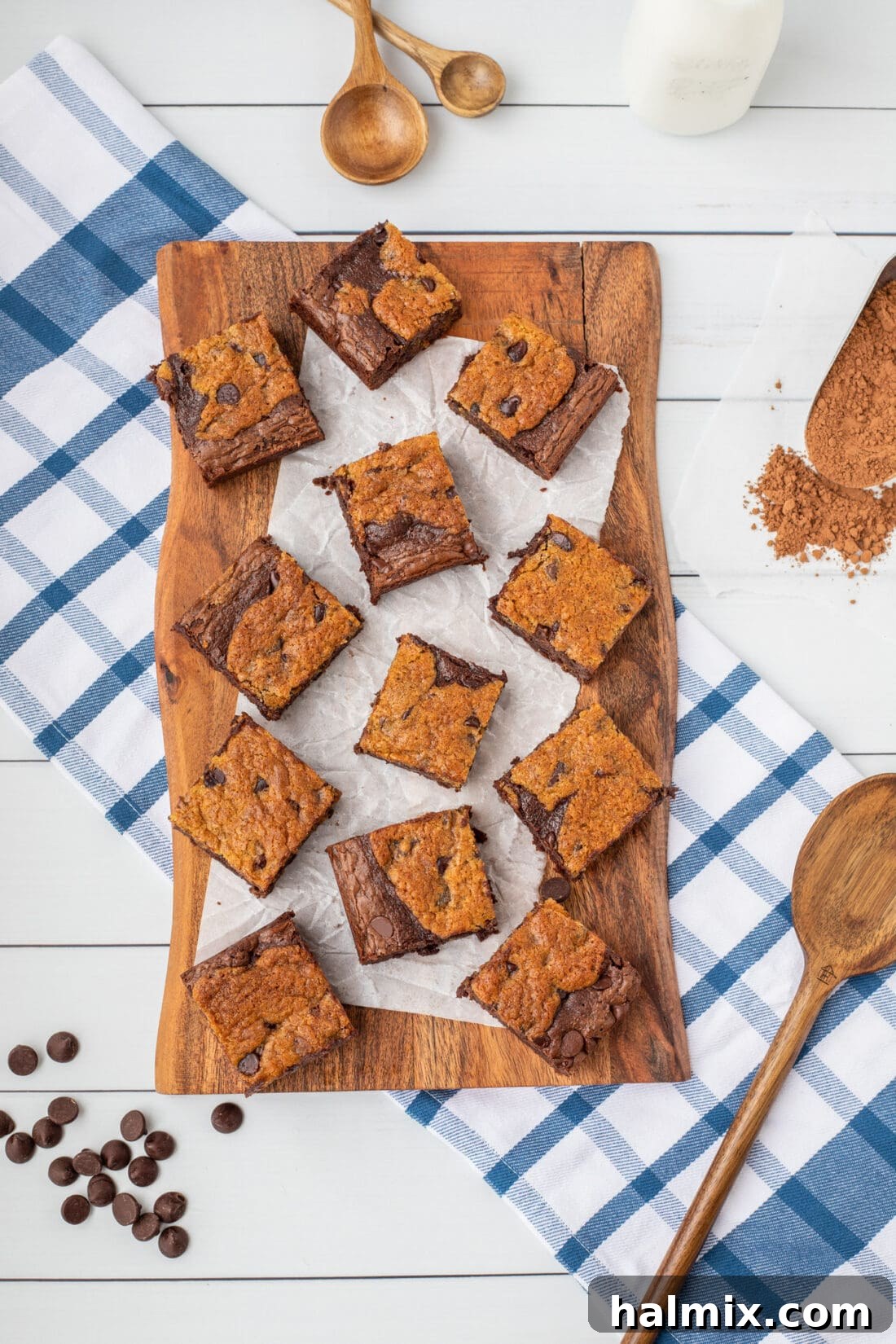 Close-up of perfectly sliced Brookies bars on a rustic wooden cutting board, showcasing their distinct layers