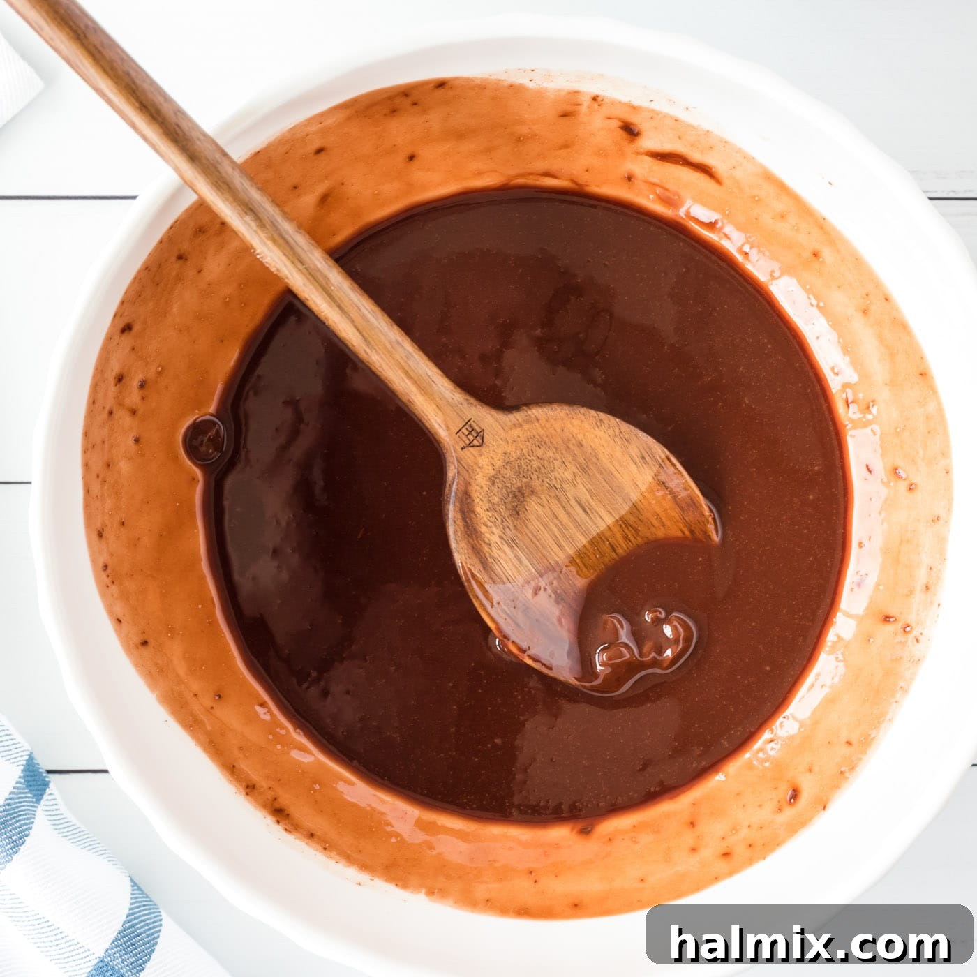 Smooth, glossy mixture of melted chocolate and butter in a bowl after stirring