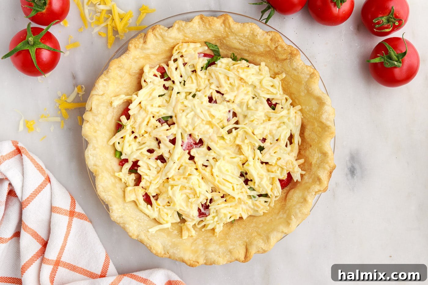cheese on top of tomato and basil in pie