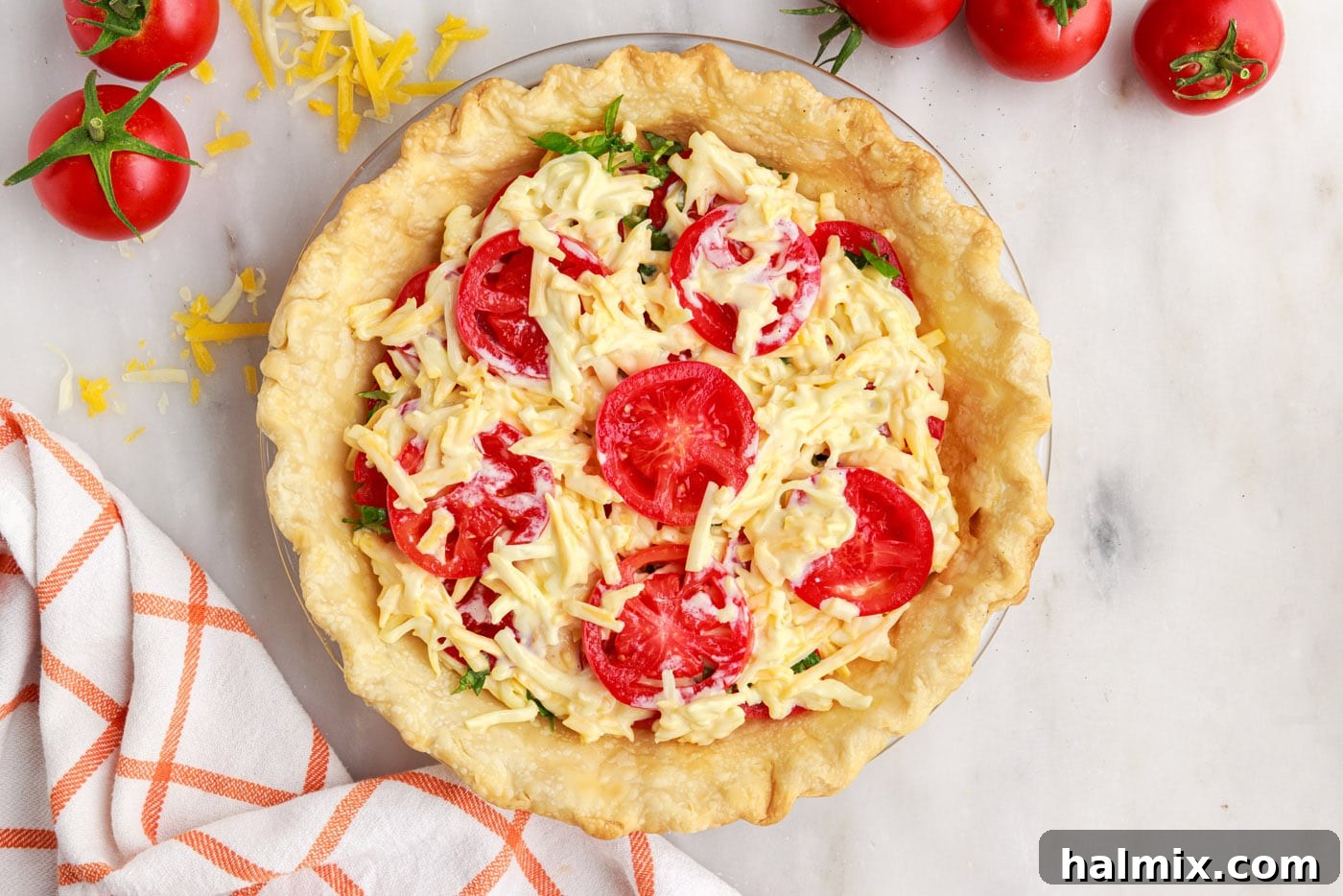 tomato, cheese, and basil layers in tomato pie