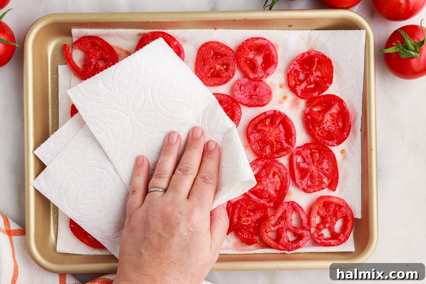 patting tomatoes dry with paper towels for tomato pie