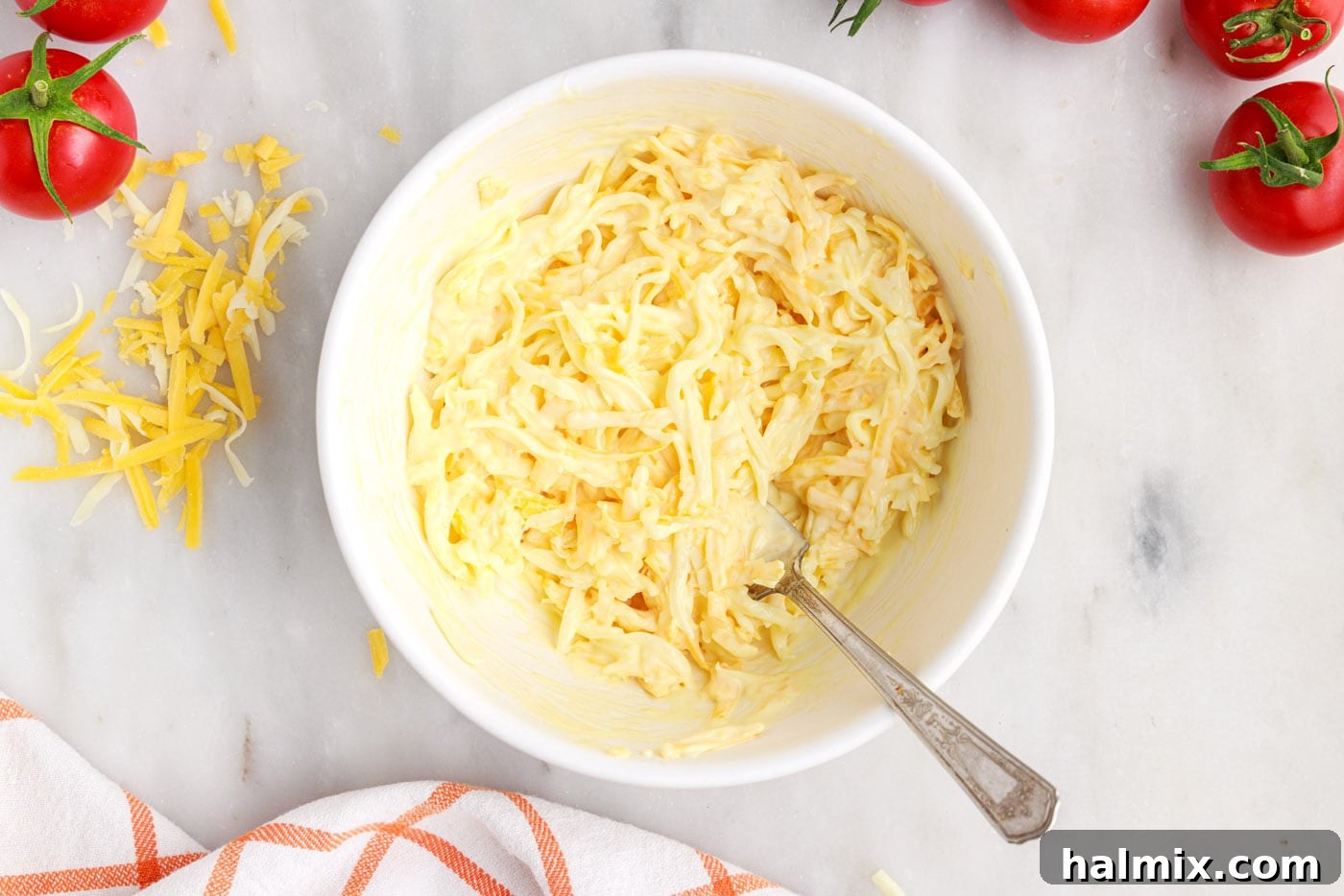 mayo egg and cheese mixed in a bowl for tomato pie