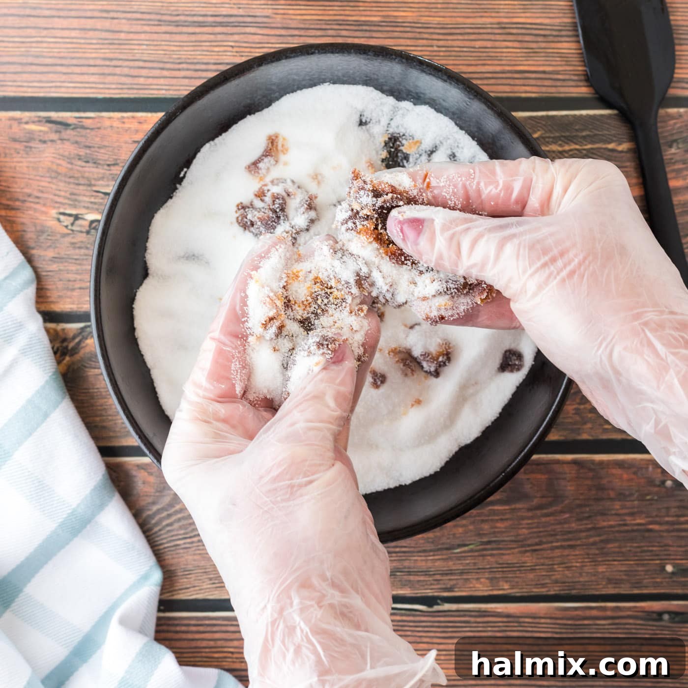 Smart Swaps for Brown Sugar 6 Hands mixing molasses and sugar together in a bowl