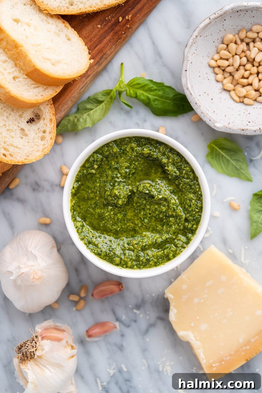 Freshly made basil pesto in a rustic bowl, garnished with a basil leaf and pine nuts, ready to serve.