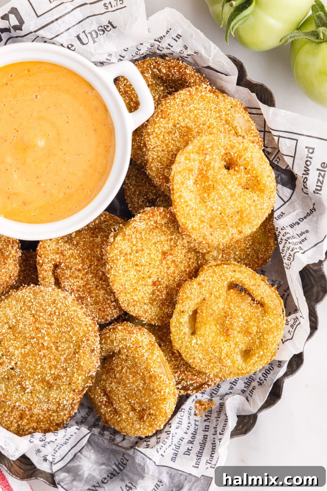 A plate of golden Fried Green Tomatoes served with a side of creamy remoulade sauce, ready to be enjoyed