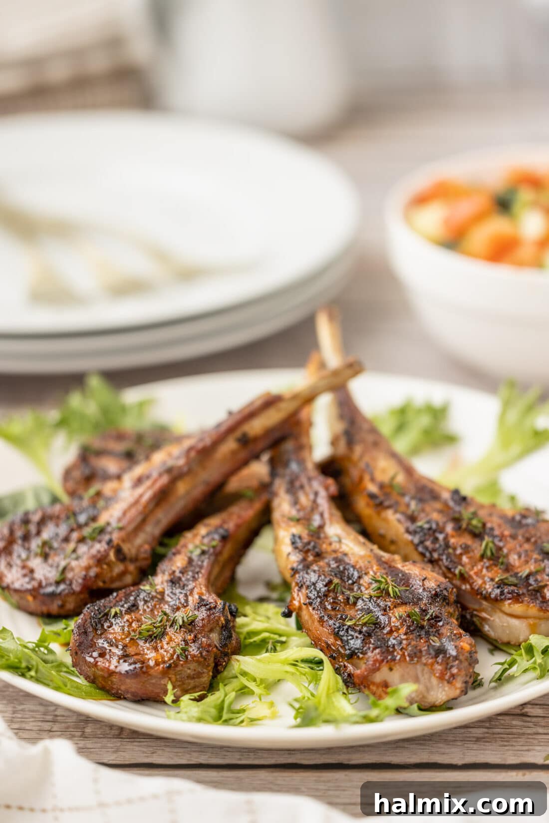 Close-up of tender Grilled Lamb Chops served on a bed of fresh lettuce