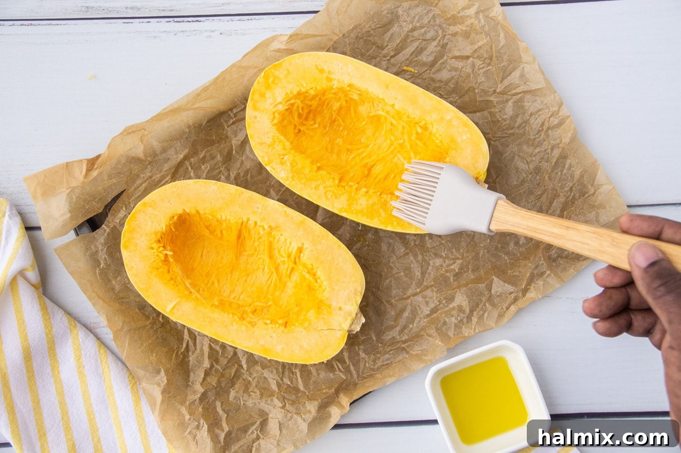 brushing olive oil on spaghetti squash