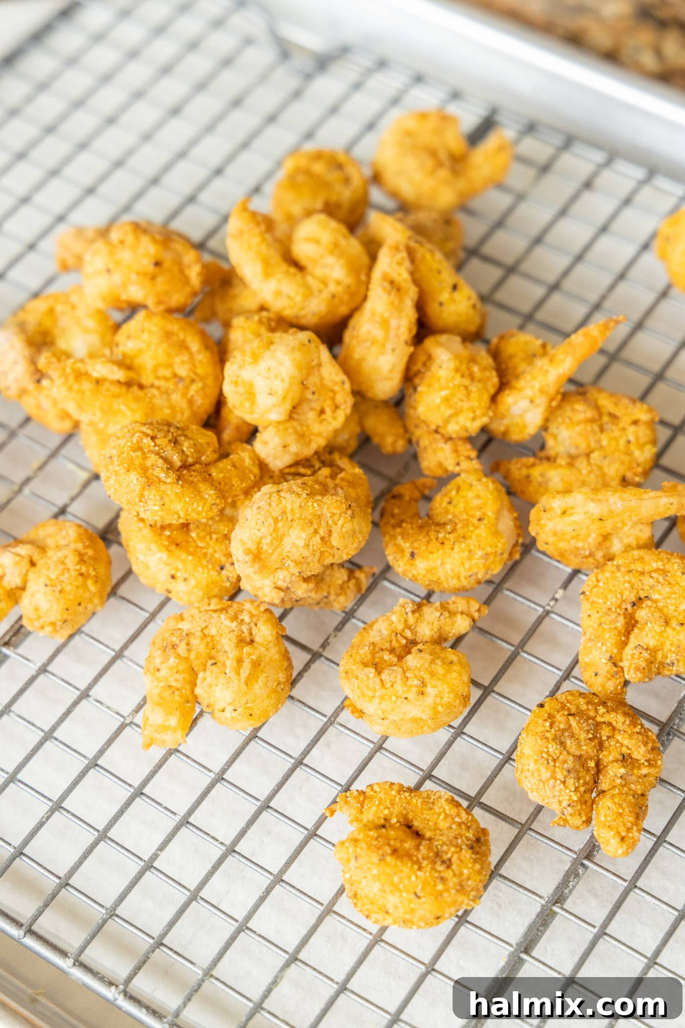 Golden Shrimp Poppers 12 popcorn shrimp on a wire rack