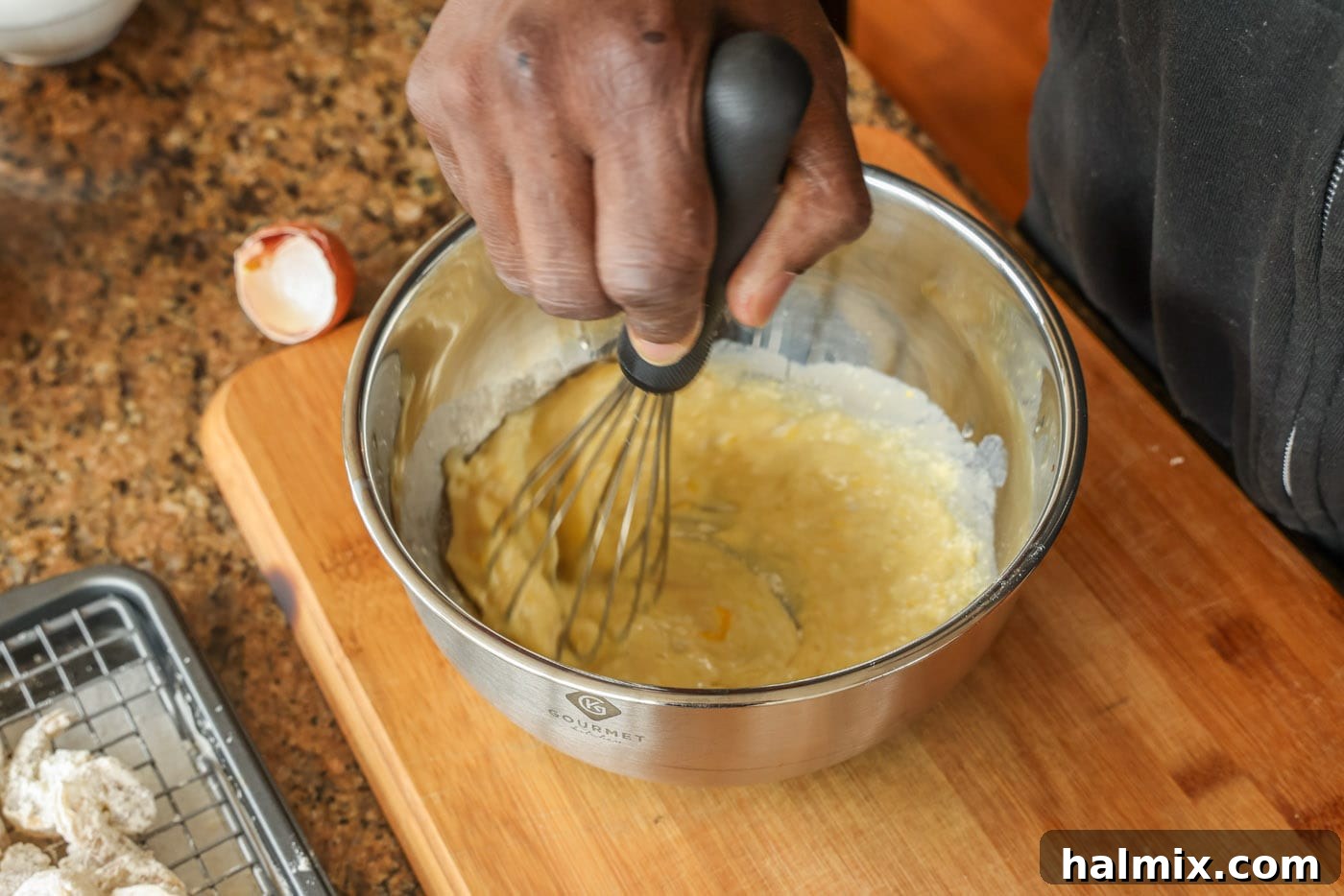 Golden Shrimp Poppers 6 whisking egg milk and flour in a bowl