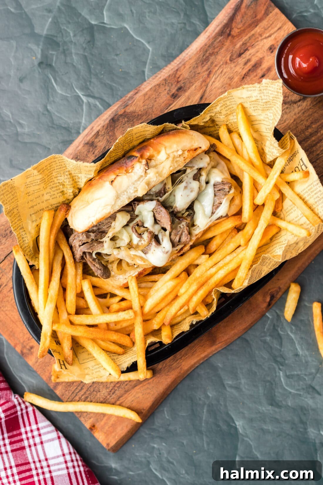 The Quintessential Philly Steak Sandwich 2 Philly Cheese Steak in basket with fries