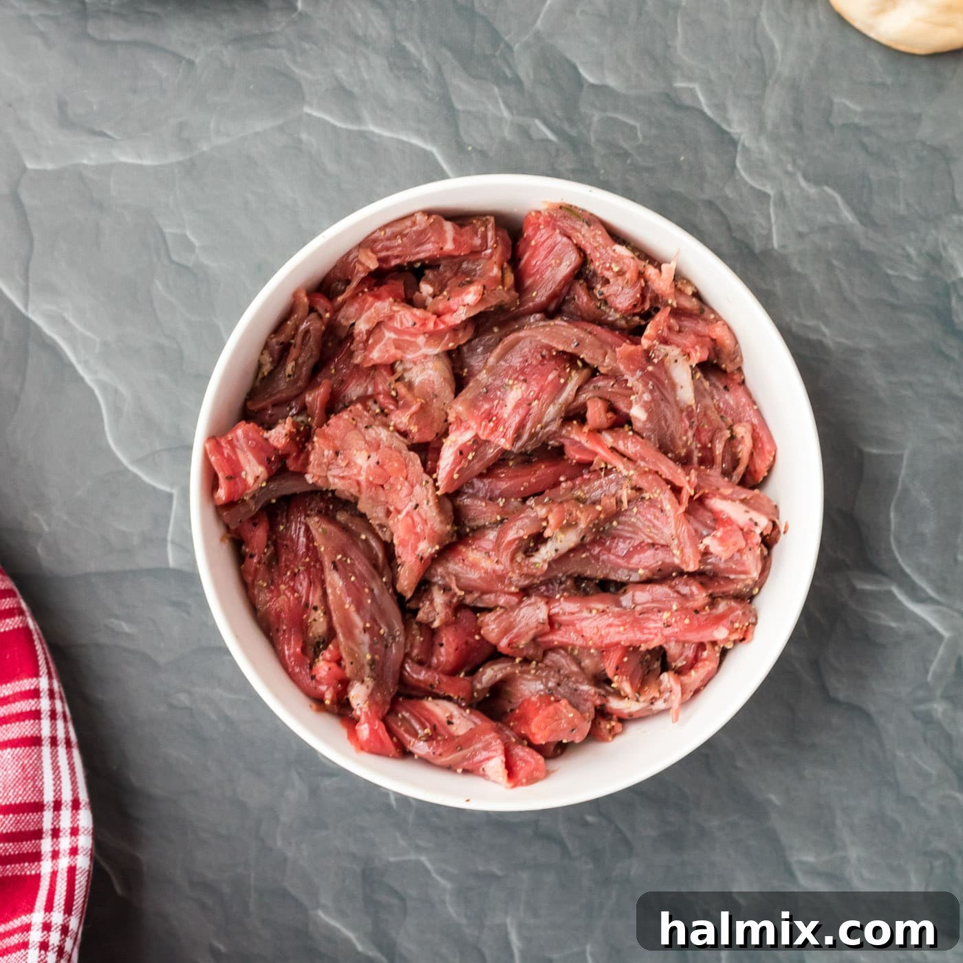The Quintessential Philly Steak Sandwich 5 sliced flank steak in a bowl