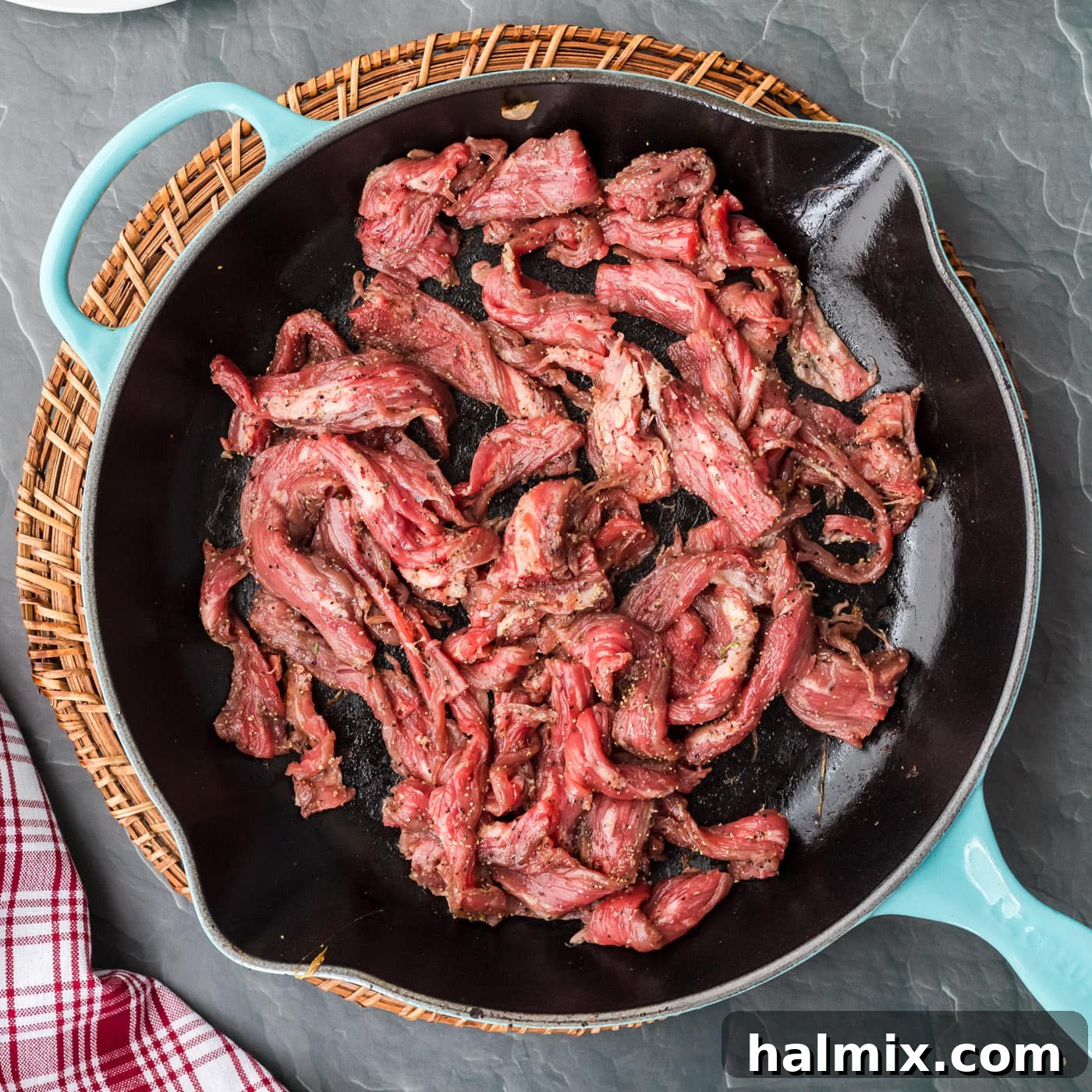 The Quintessential Philly Steak Sandwich 9 beef strips in a skillet
