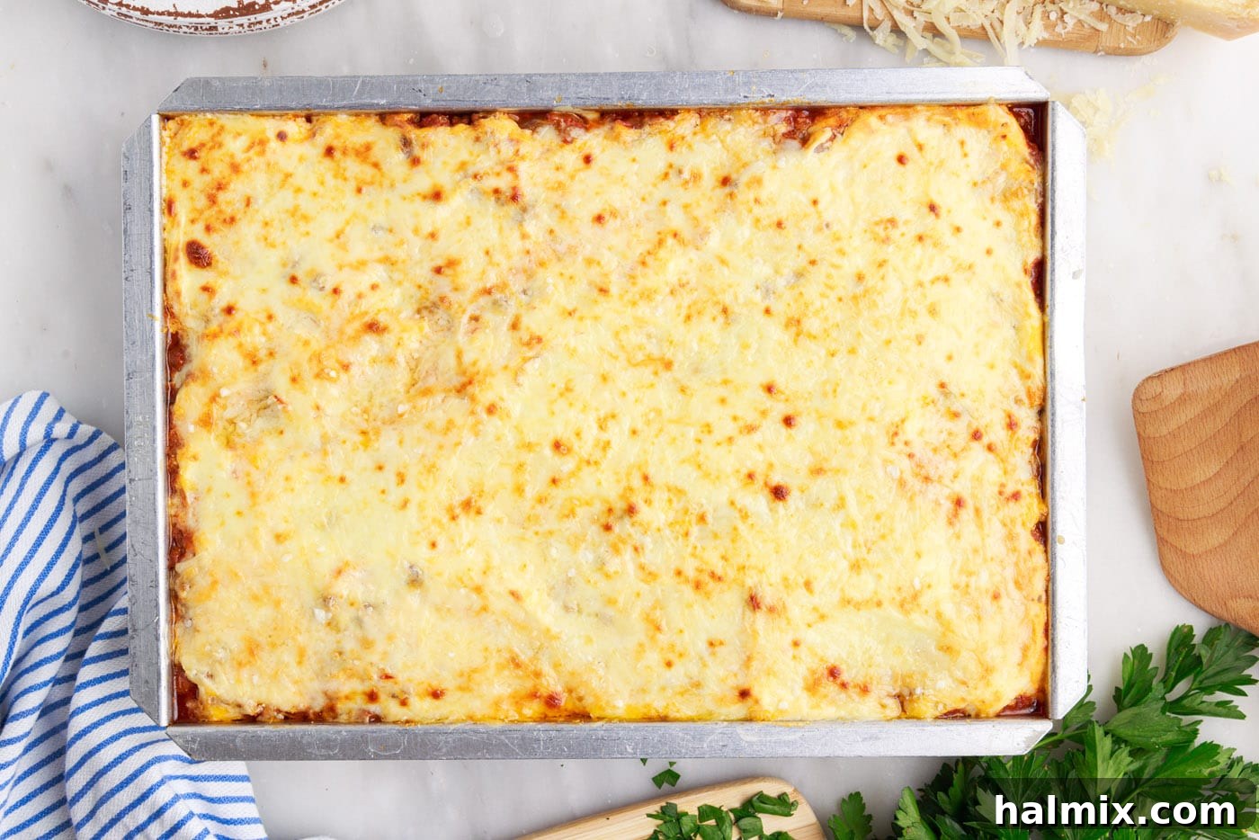 Freshly baked Million Dollar Spaghetti casserole, hot and bubbling, with a perfectly melted, golden-brown cheese crust.