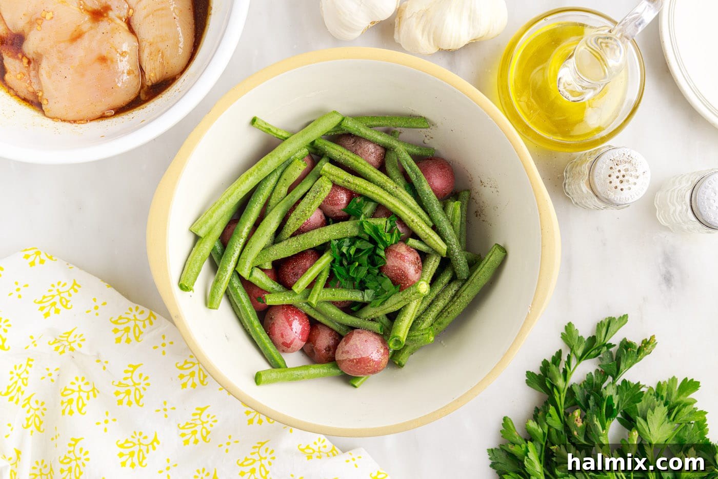 Easy Campfire Foil Meals 7 Green beans and baby potatoes seasoned in a bowl