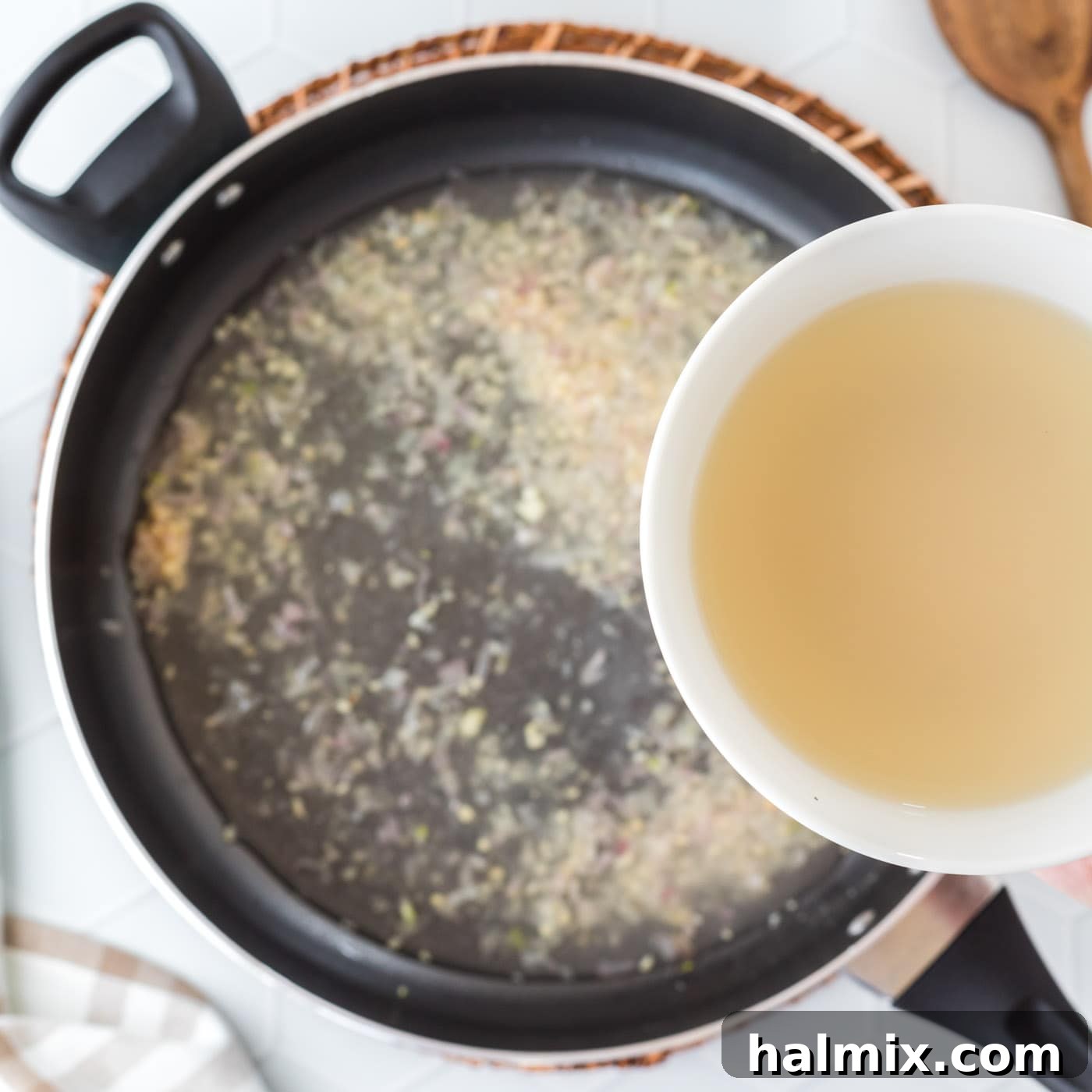 pour clam juice into pan with shallots and garlic