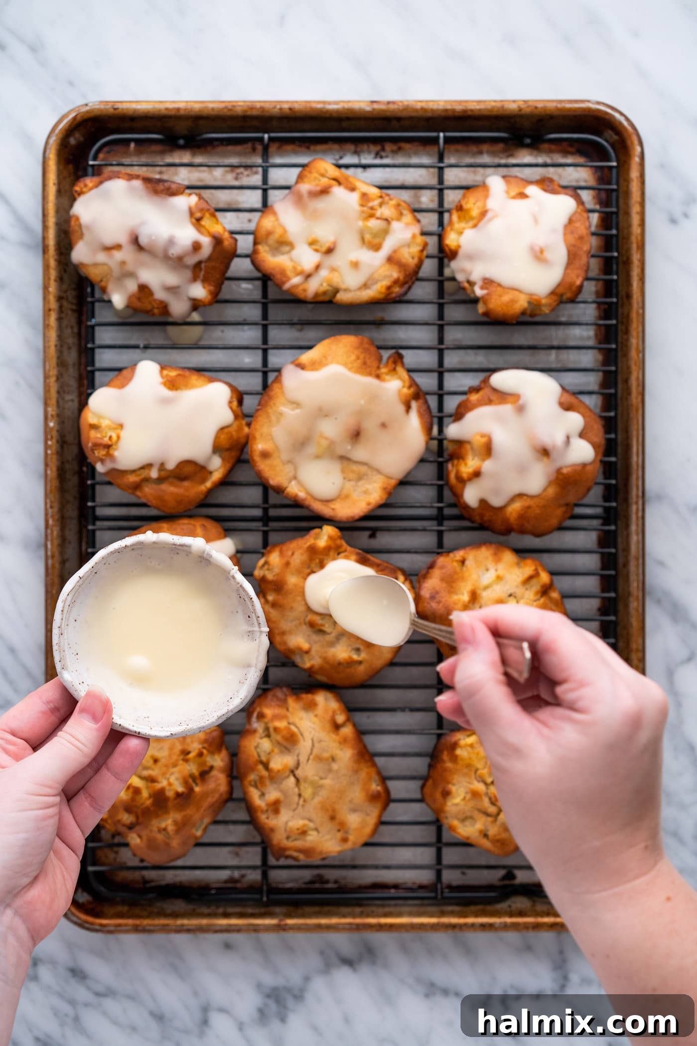 spooning glaze over apple fritters