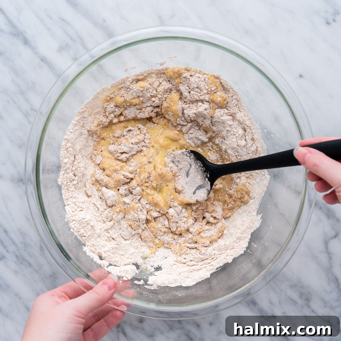 mixing apple fritter batter in a bowl with spatula