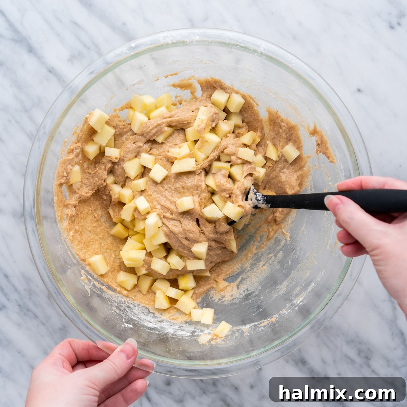 folding chopped apples into apple fritter batter