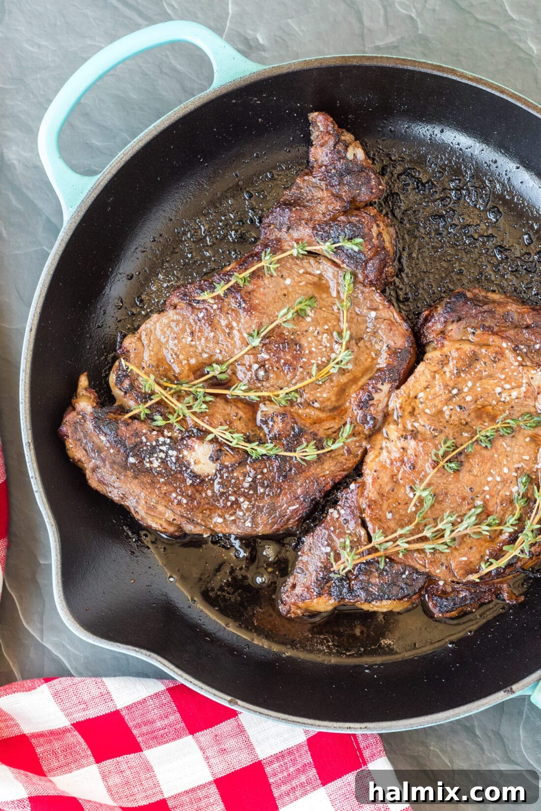 Reverse Sear Ribeye in skillet, showing a beautiful, dark crust forming.