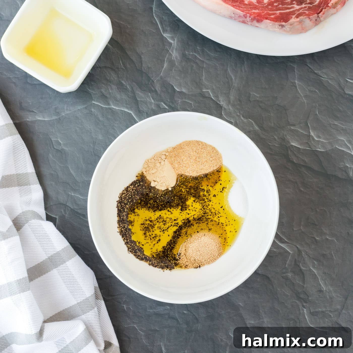 Steak wet rub ingredients in a bowl, showing the mixed spices and oil.