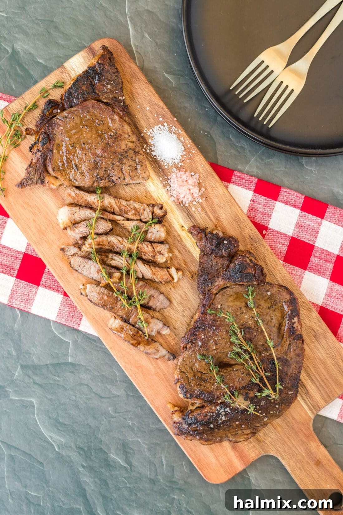 Reverse Sear Ribeye on board, perfectly sliced and ready to serve.