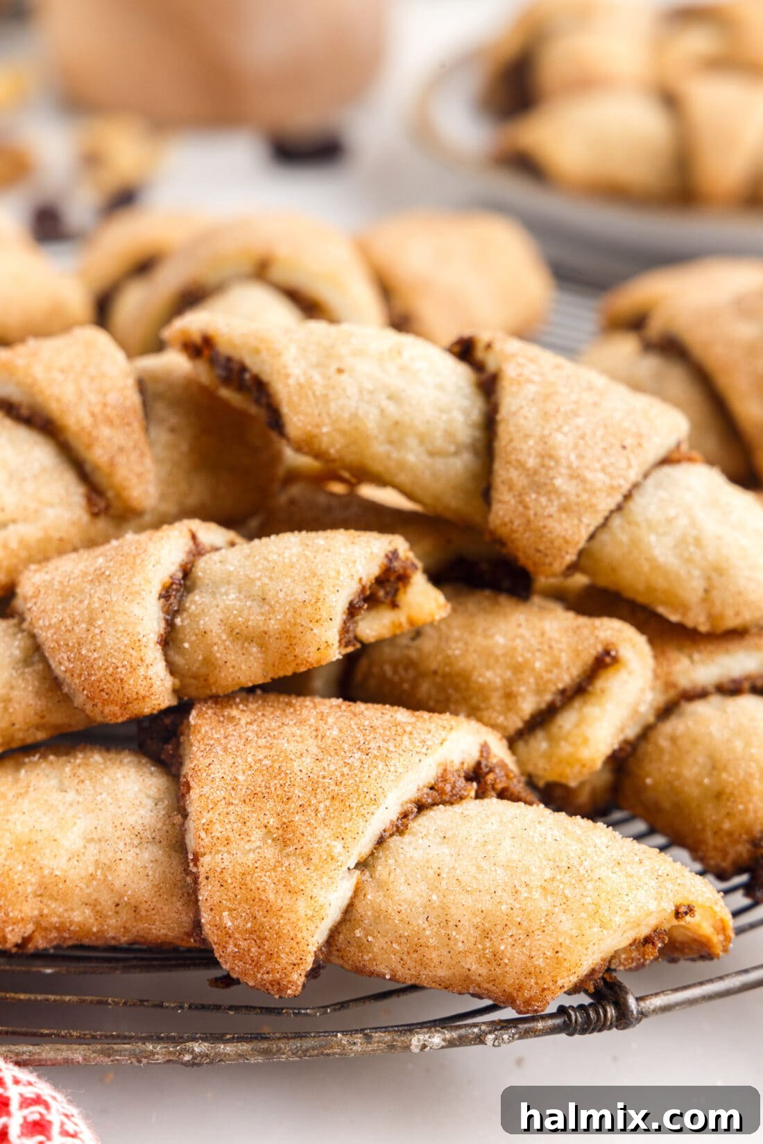 A beautiful pile of freshly baked Rugelach cookies, golden brown and glistening with cinnamon sugar.