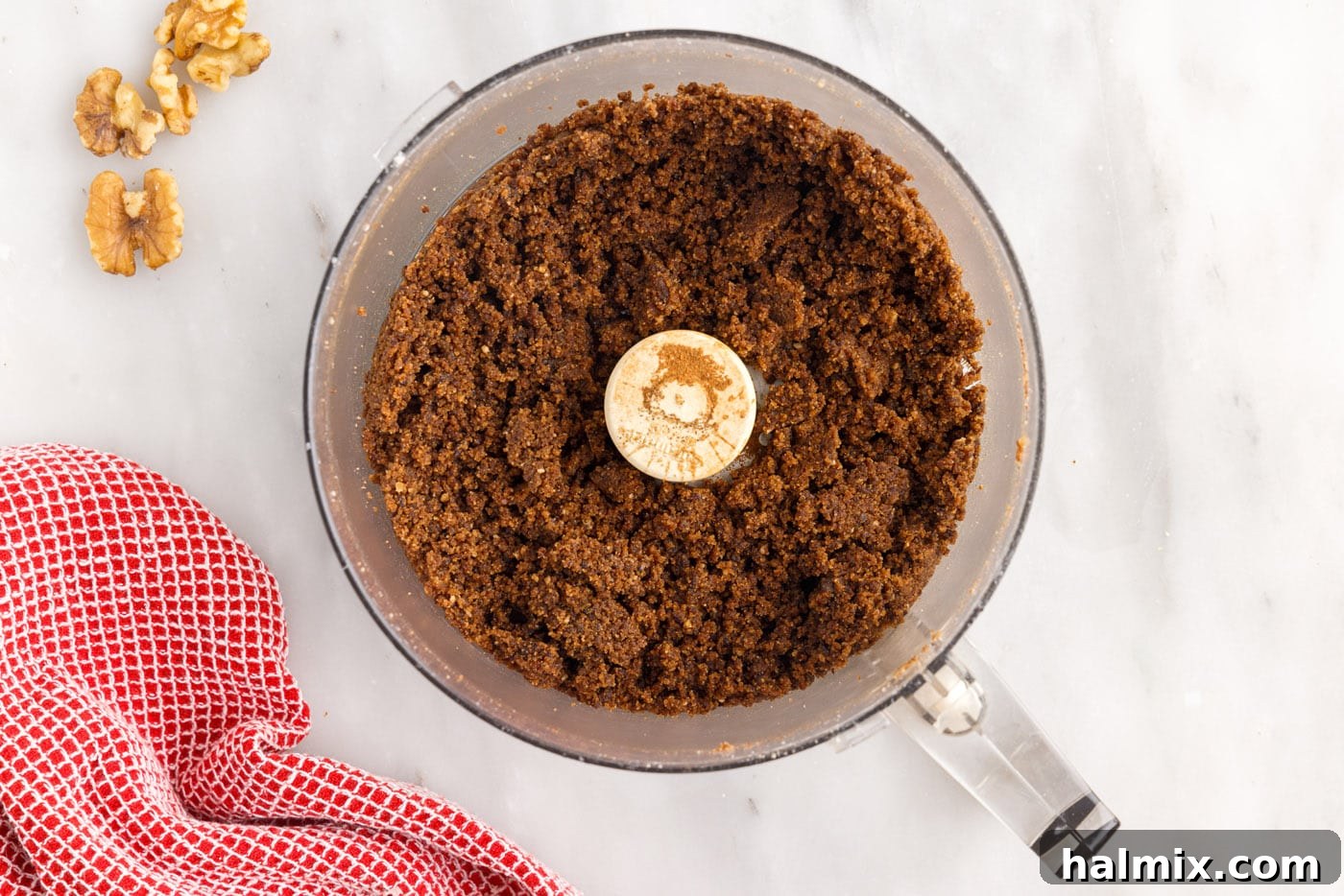 A close-up of the walnut, raisin, and cinnamon sugar filling being processed in a food processor.