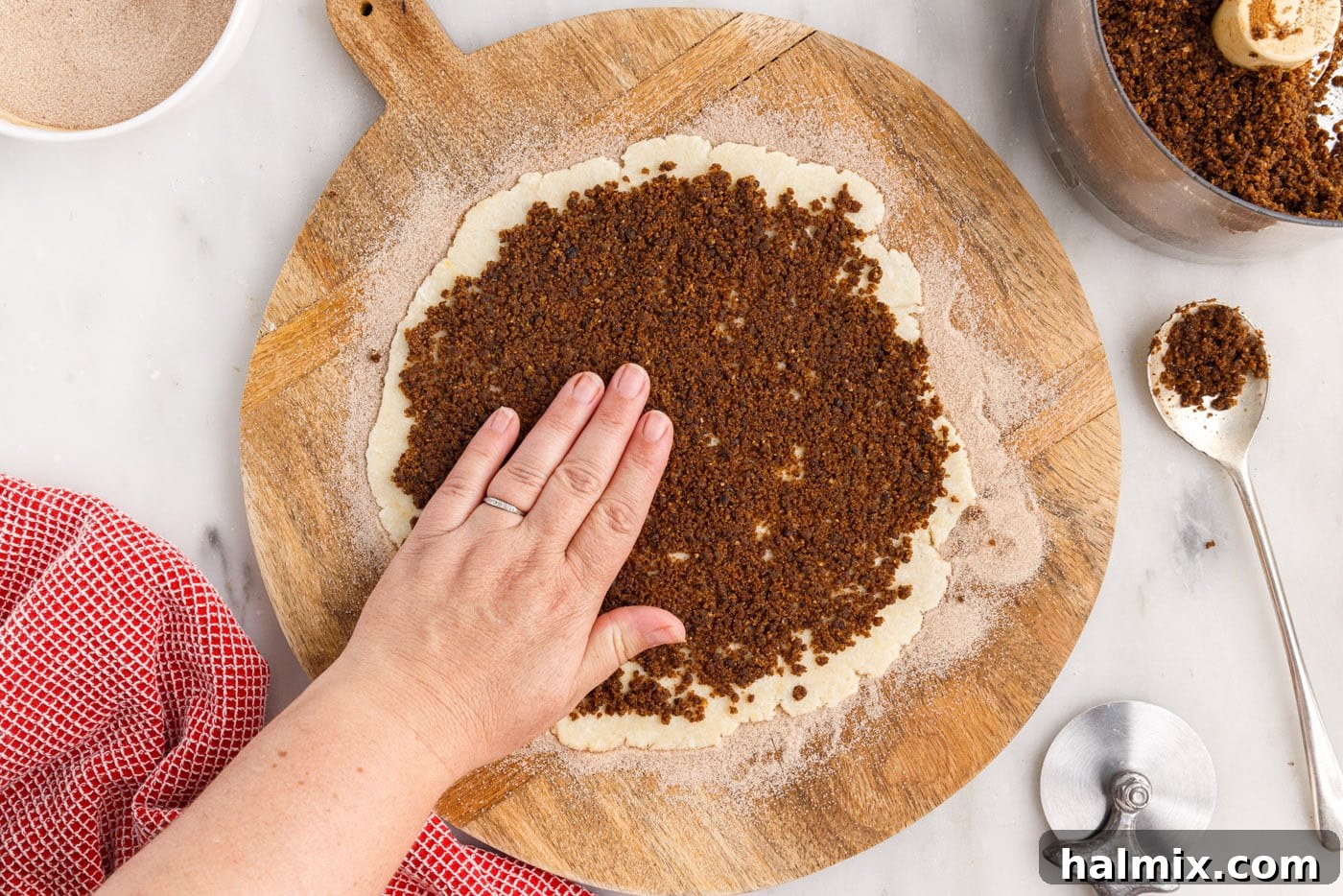 A closer view of the rugelach dough with the cinnamon raisin filling spread, ready for cutting.