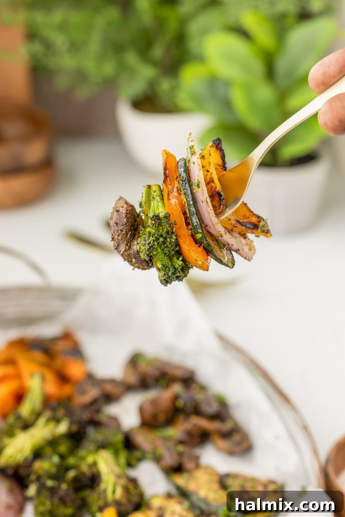 Flame-Kissed Veggie Delights 3 A forkful of perfectly grilled bell pepper and zucchini, showing tender texture and char.