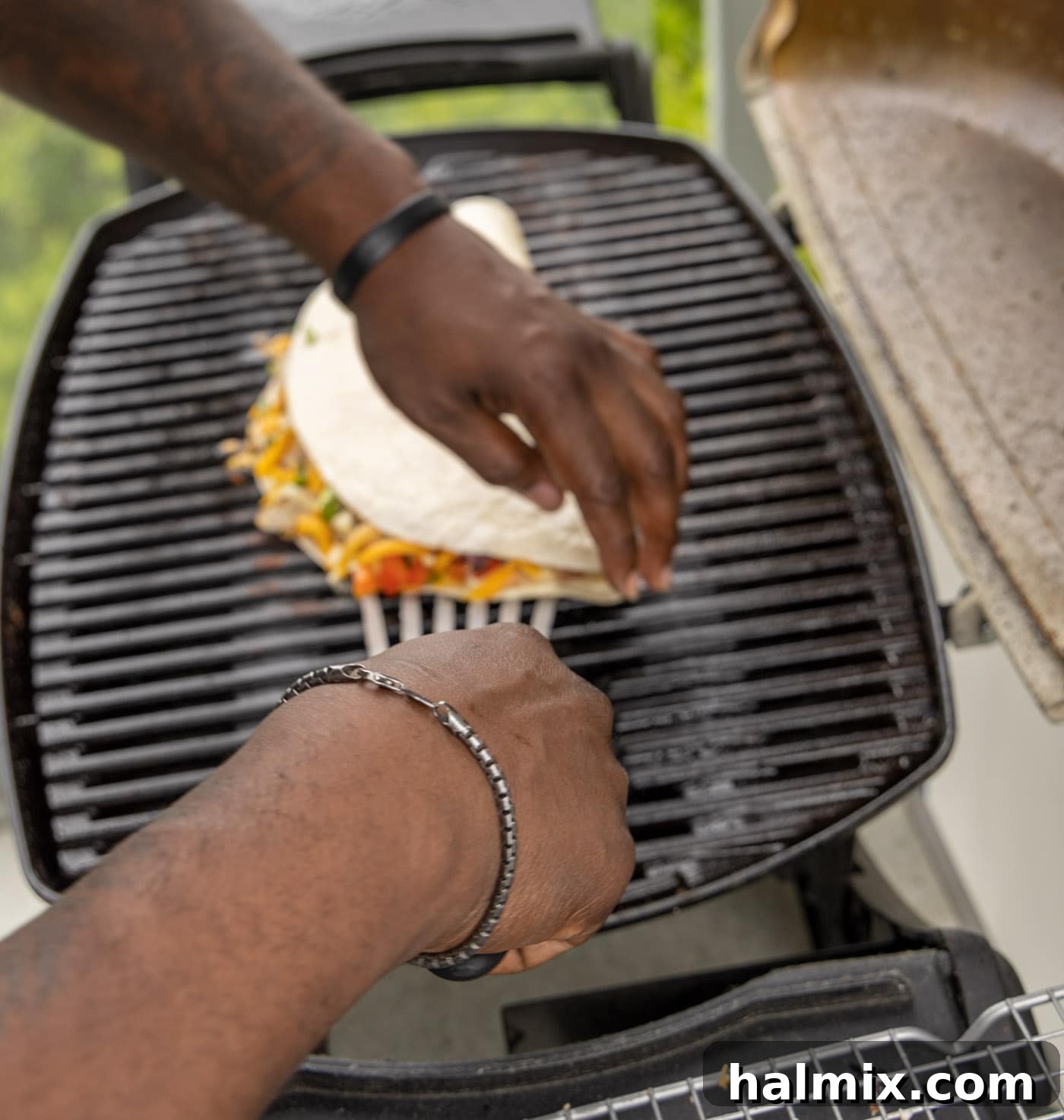 Grilled Chicken & Cheese Fiesta 11 Flipping a grilled chicken quesadilla on the grill to cook the other side